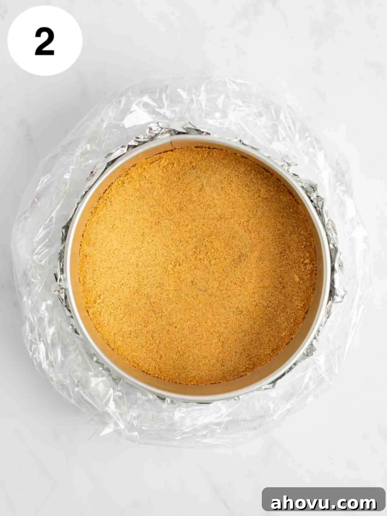 Your Guide to a Perfect Cheesecake Water Bath 6 A graham cracker crust in a springform pan that's wrapped in foil and an oven bag