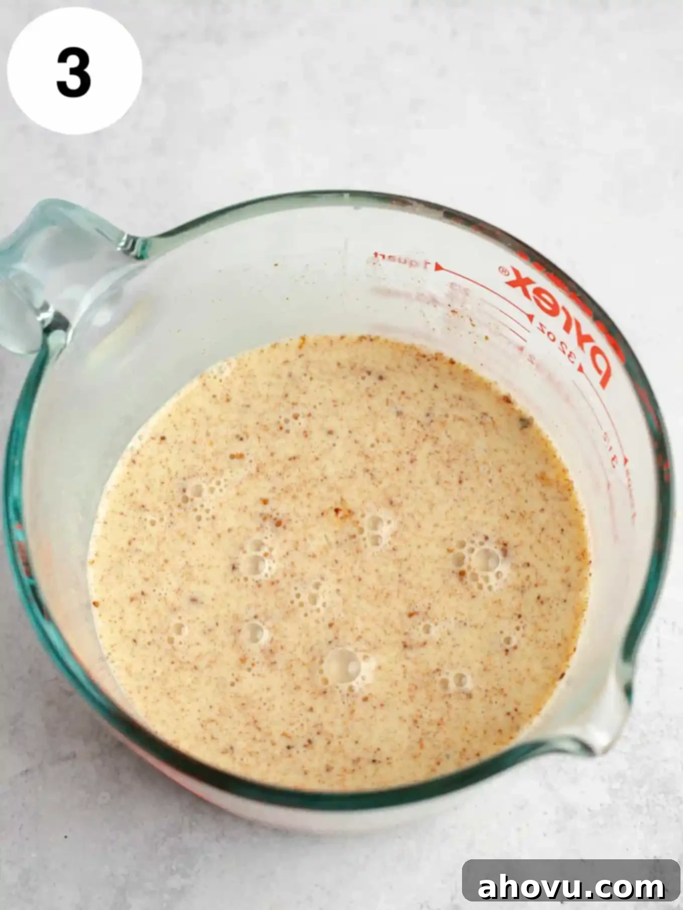 The custard whisked together in a large measuring cup.