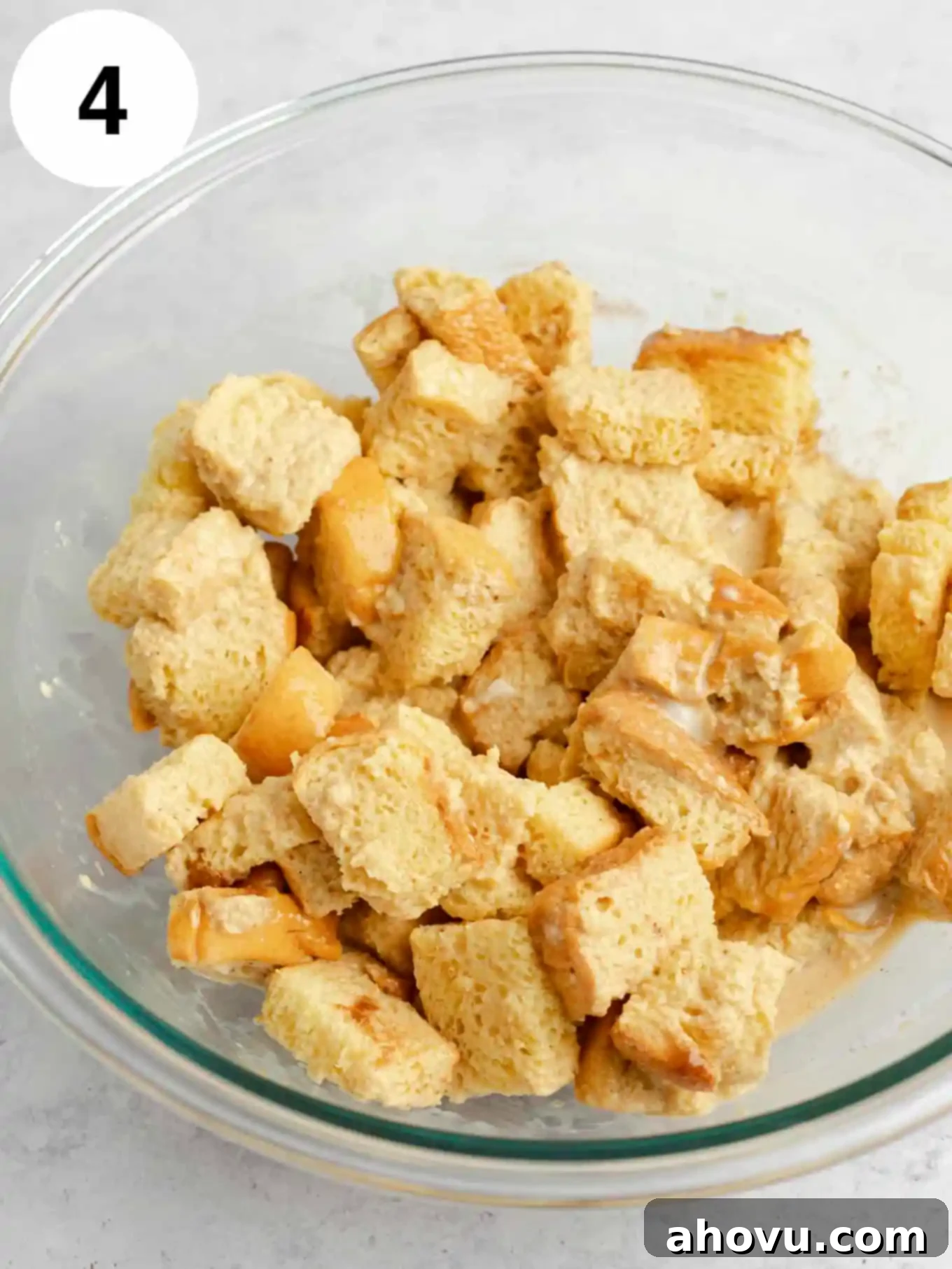 Cubed bread coated in the custard mixture.