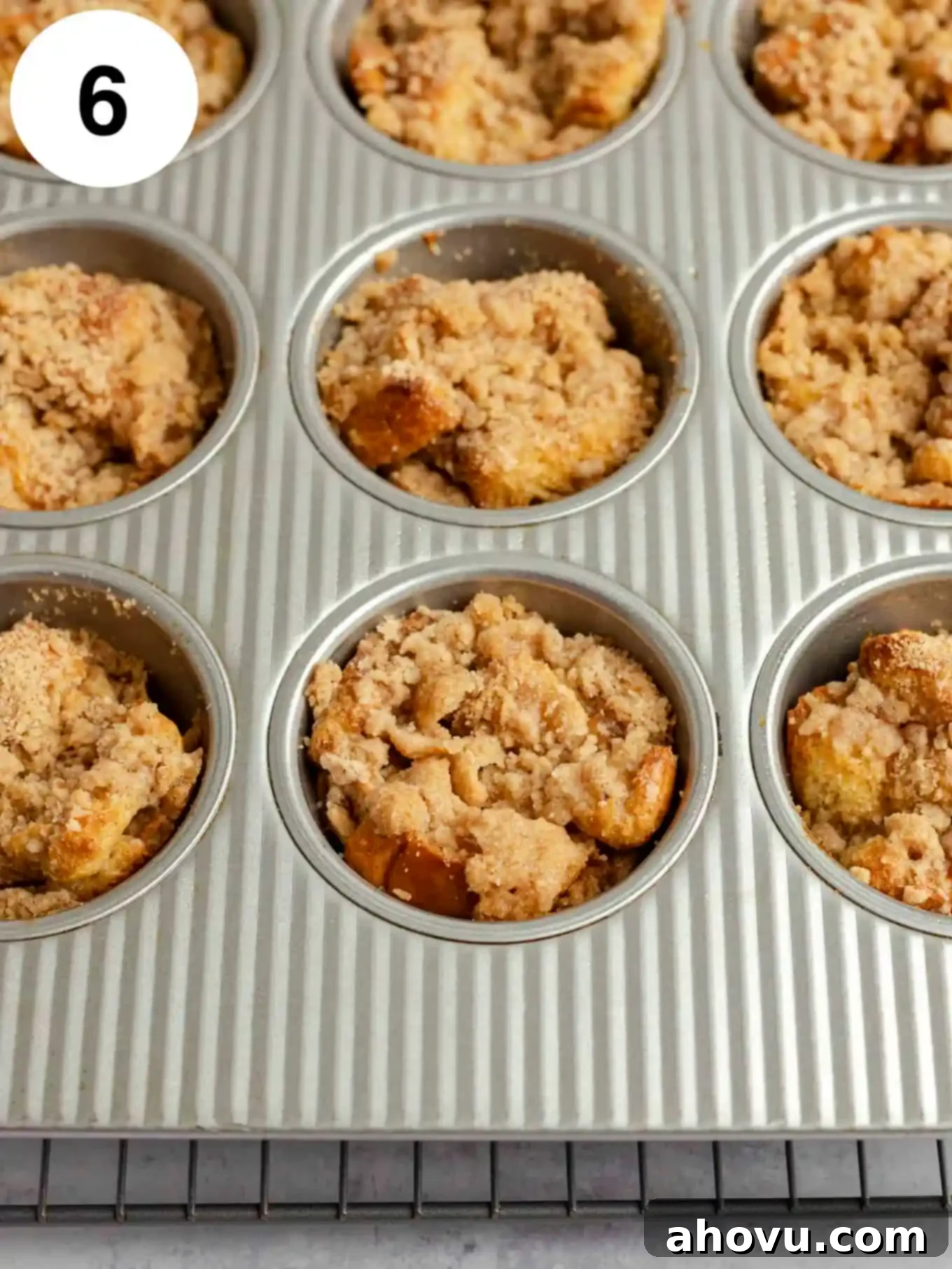 Baked French toast muffins in a muffin pan.