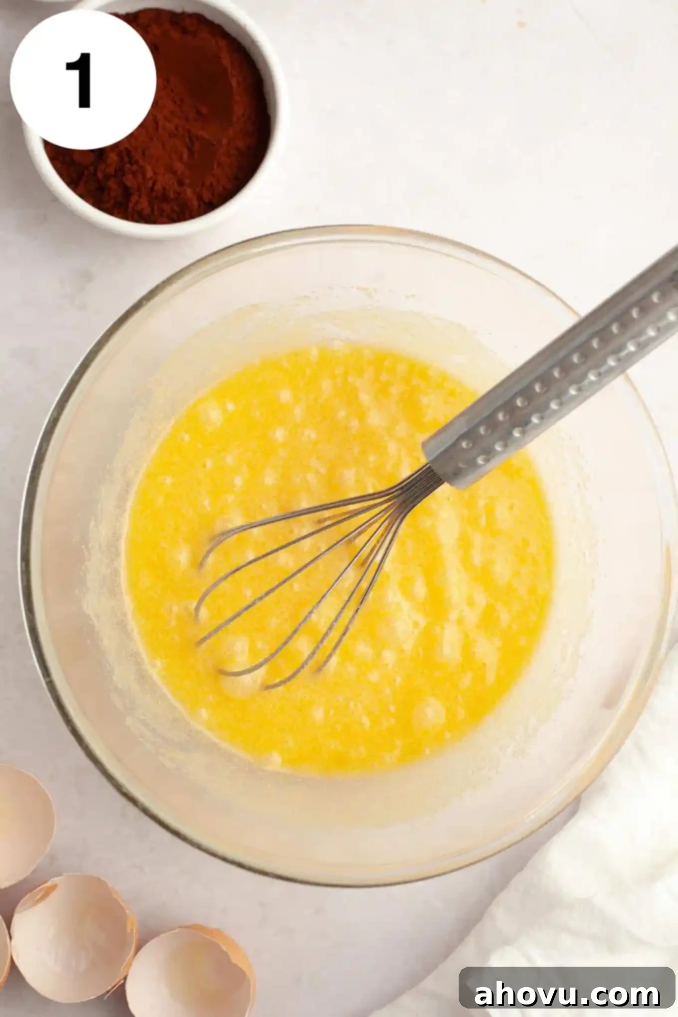 Gems of the Current 4 An overhead view of melted butter and sugar in a glass mixing bowl, with a whisk.