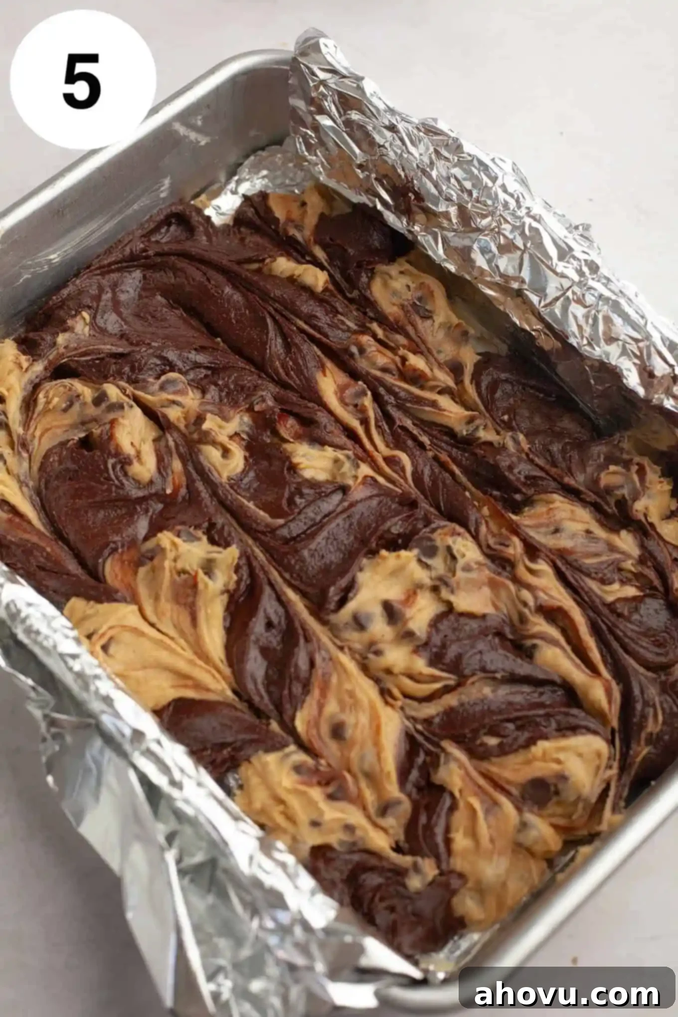 Gems of the Current 8 An overhead view of raw brookie batter in a foil-lined pan.