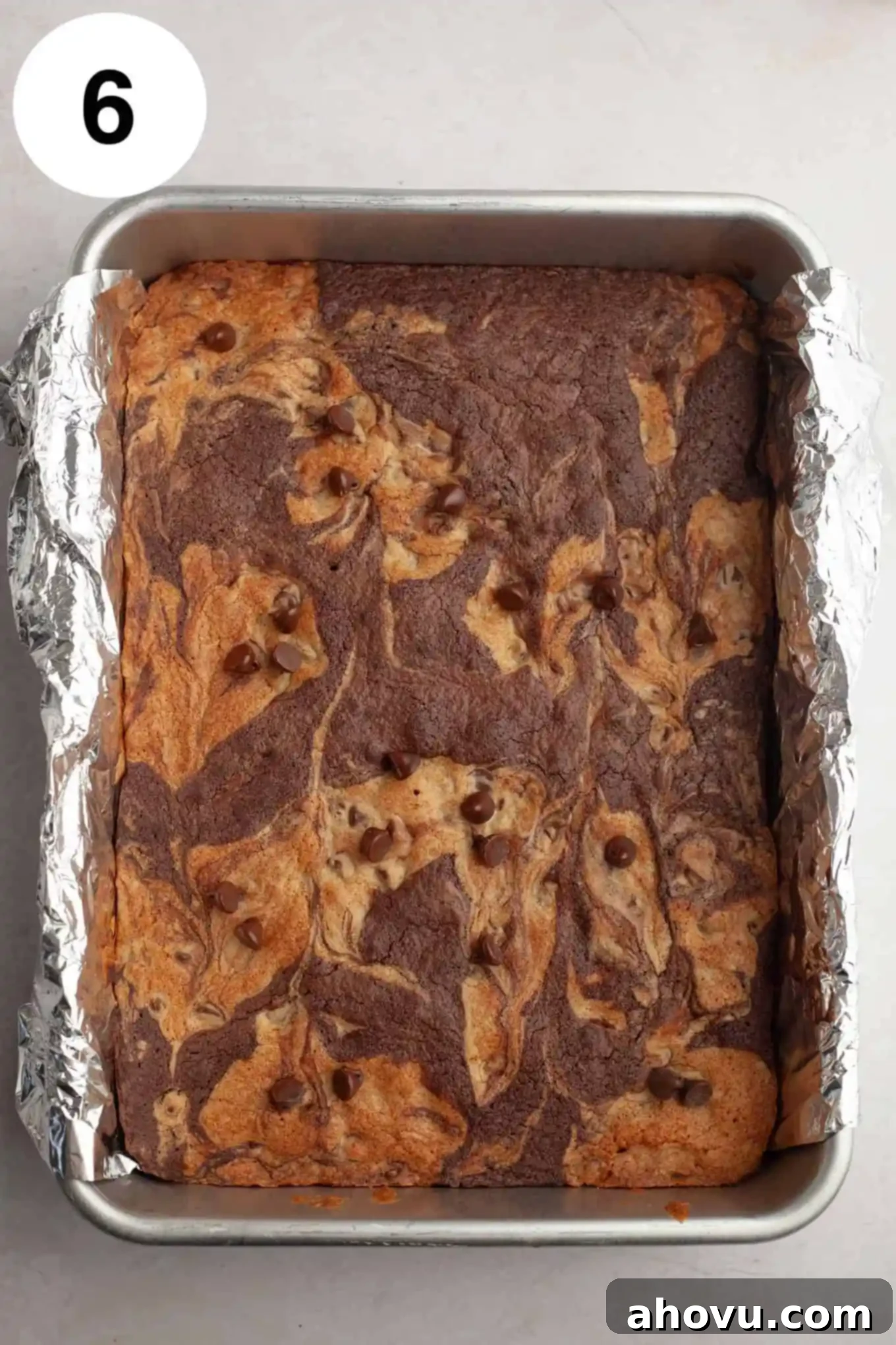 Gems of the Current 9 An overhead view of baked brookie bars in a foil-lined pan.