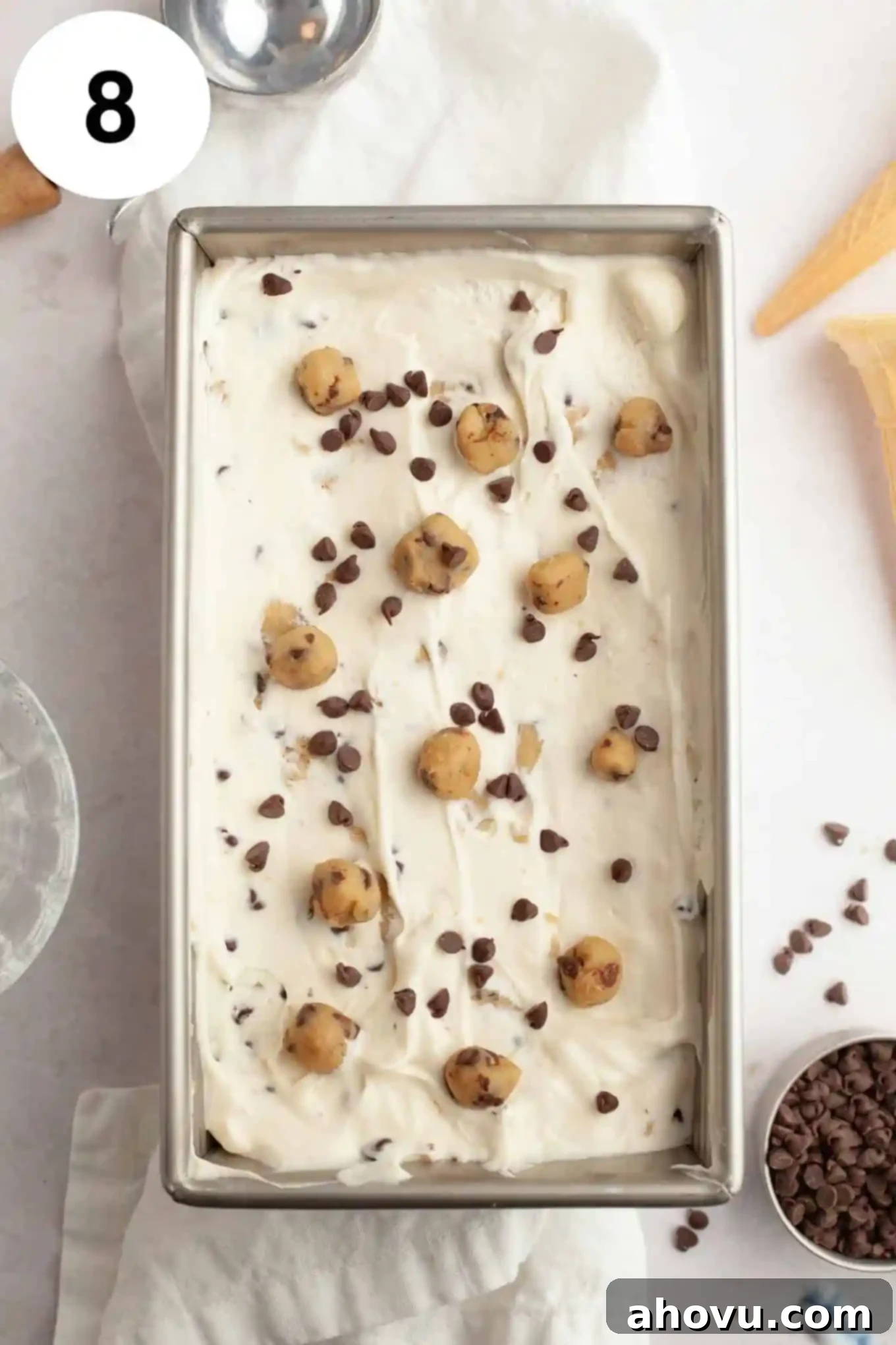 An overhead view of cookie dough ice cream in a metal loaf pan. 