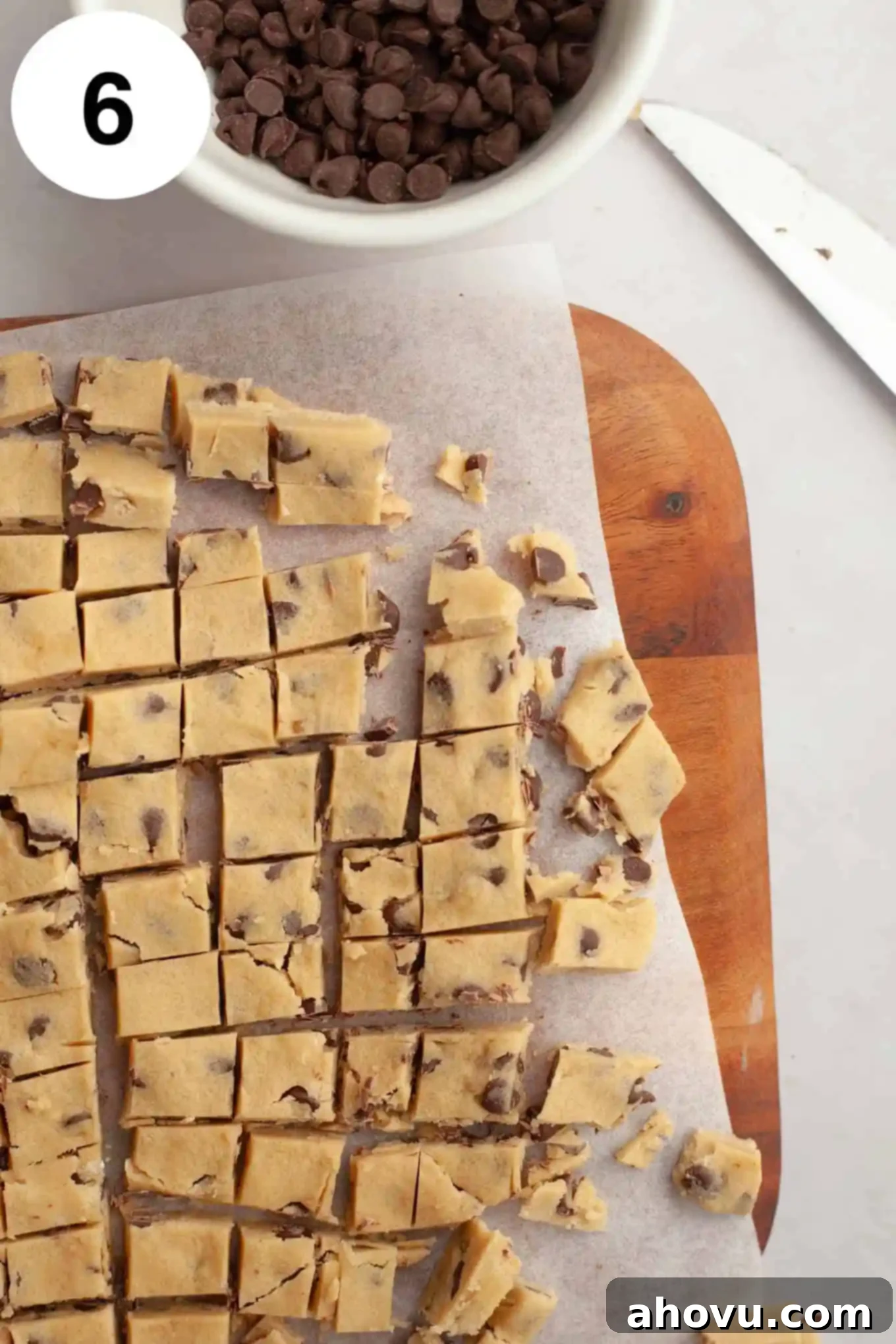An overhead view of edible chocolate chip cookie dough cut into bite-sized pieces. 