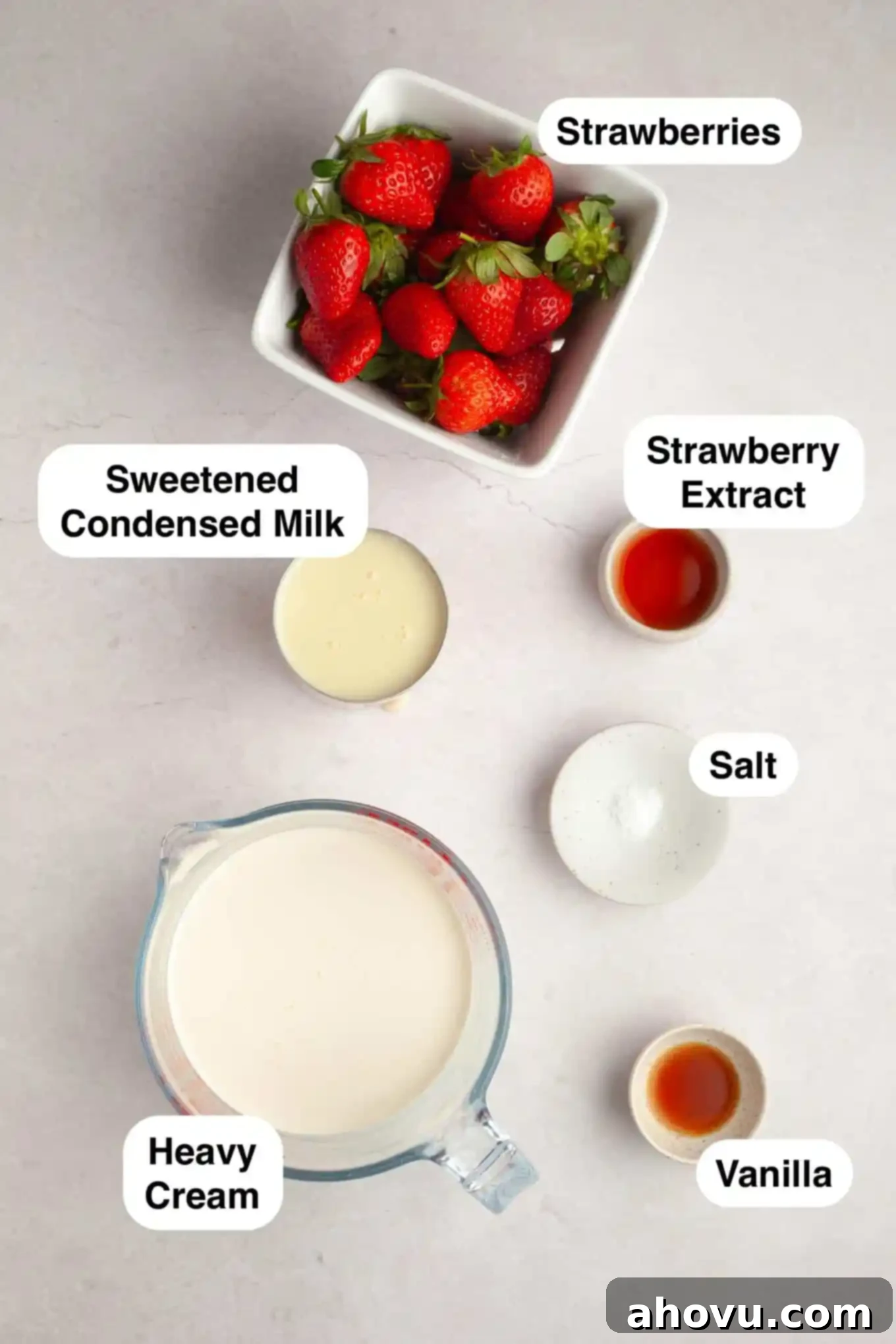 An overhead view showcasing all the fresh and simple ingredients neatly laid out on a clean surface, ready to be transformed into homemade strawberry ice cream.