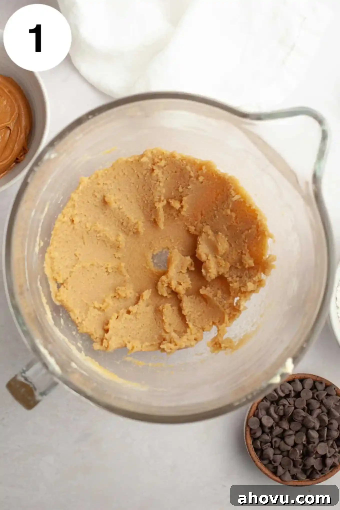 Irresistible Peanut Butter Chocolate Chip Cookies 4 An overhead view of butter and sugar creamed together in a glass mixing bowl.