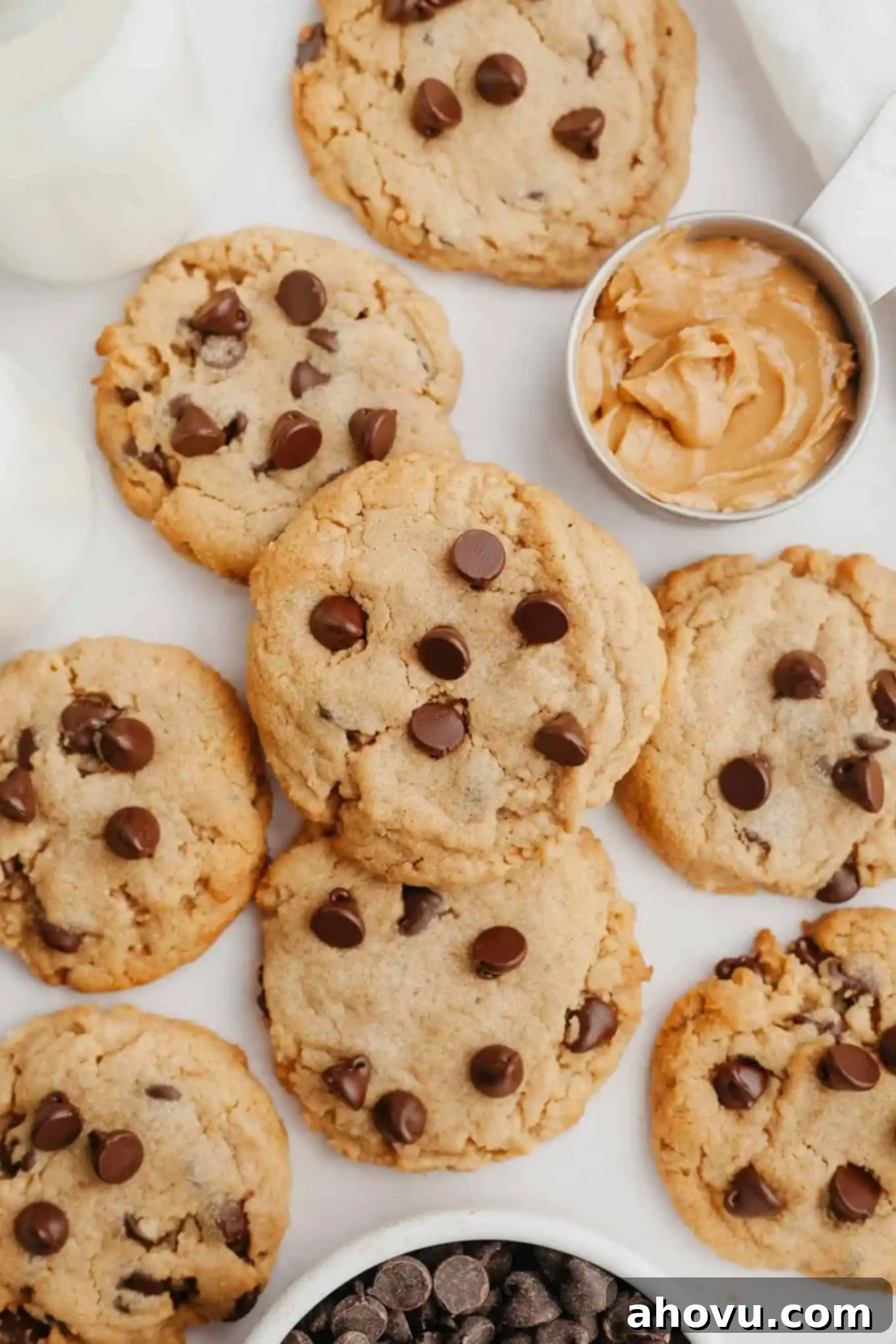 Irresistible Peanut Butter Chocolate Chip Cookies 10 An overhead view of a pile of peanut butter cookies with chocolate chips.
