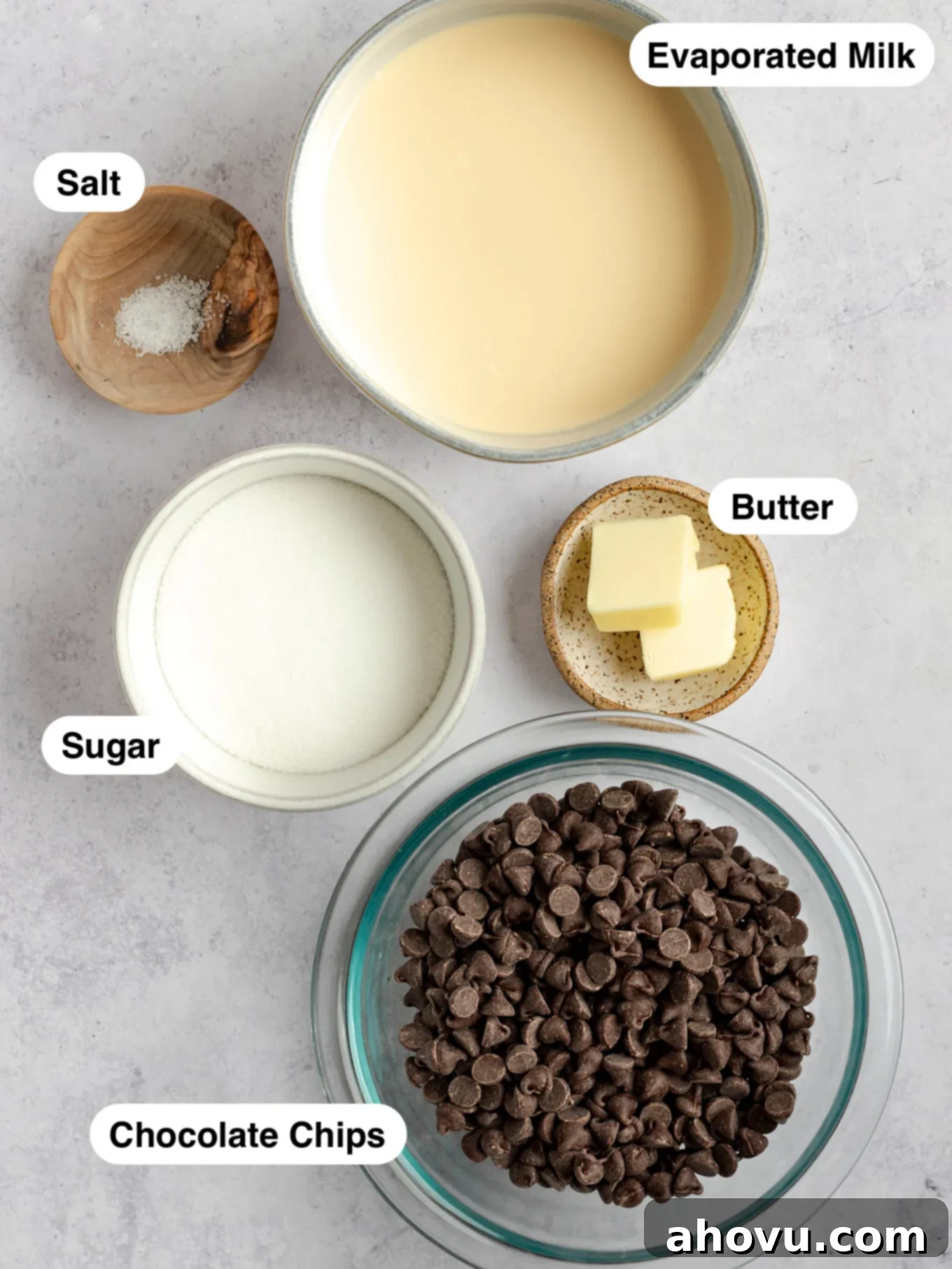 An overhead shot showcasing the five essential ingredients laid out on a clean surface, ready for making homemade hot fudge sauce.