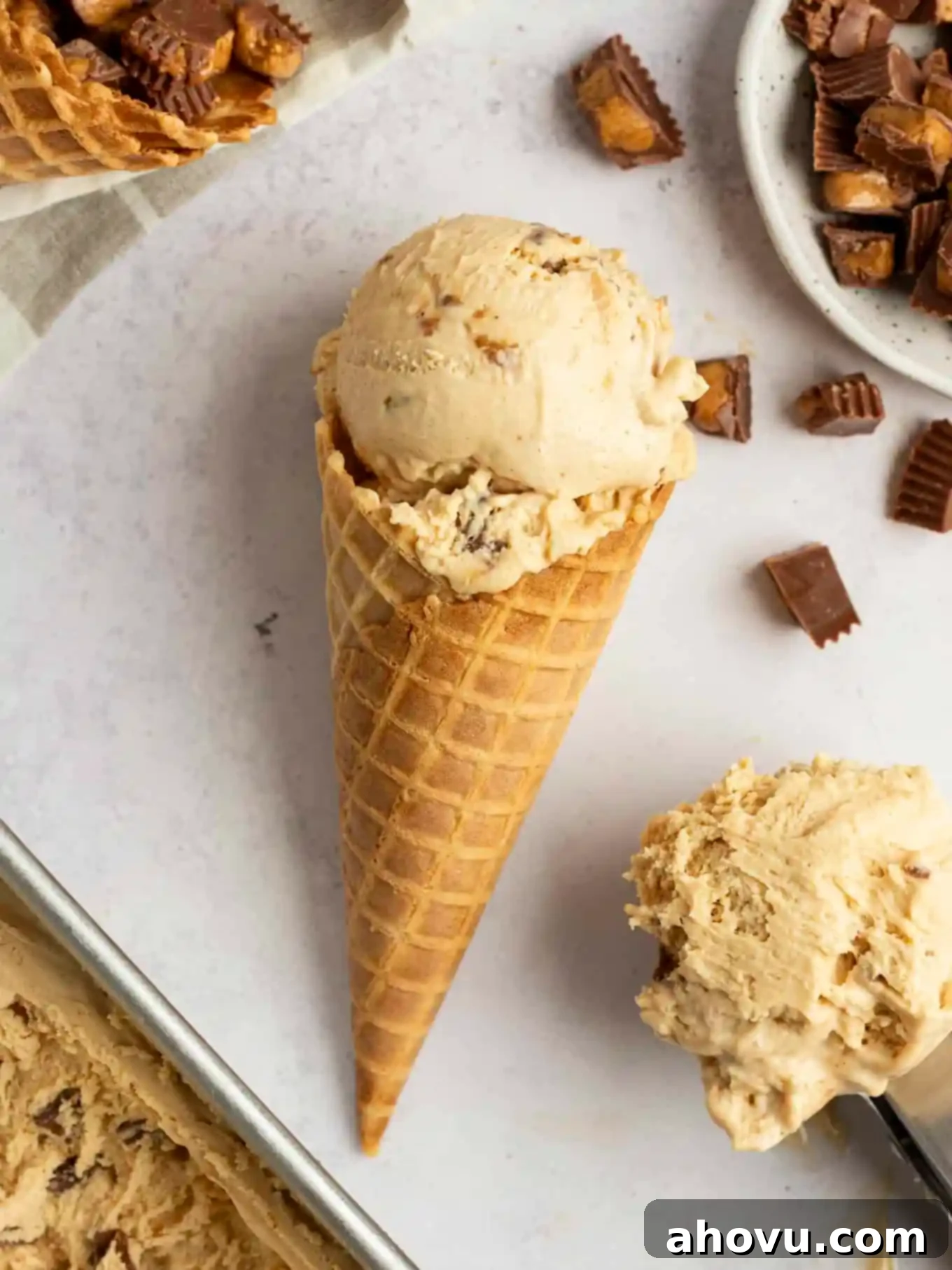 Velvet Peanut Butter Freeze 11 A crispy waffle cone filled with creamy peanut butter ice cream, lying on its side.