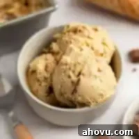 Velvet Peanut Butter Freeze 12 A bowl filled with three scoops of homemade peanut butter ice cream, topped with chopped peanut butter cups.