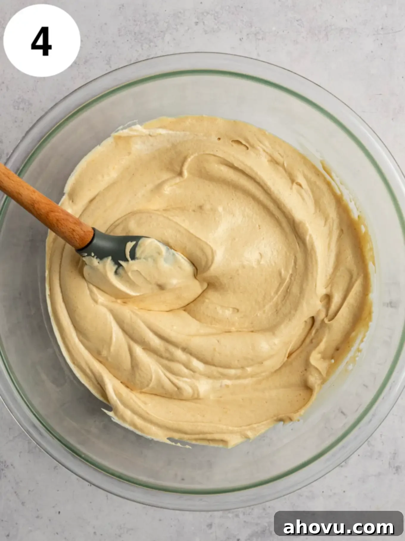 Velvet Peanut Butter Freeze 7 An overhead view of the peanut butter ice cream base, light and airy, in a glass mixing bowl with a rubber spatula.