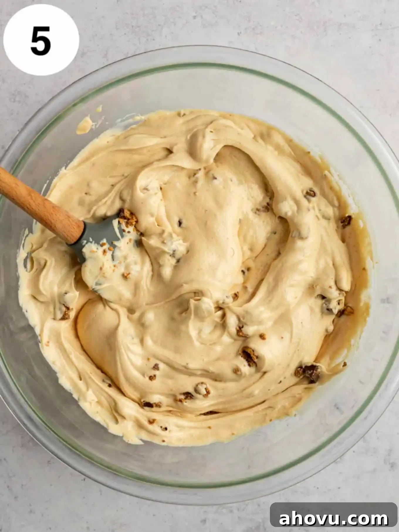 Velvet Peanut Butter Freeze 8 An overhead view of the peanut butter ice cream base with chopped peanut butter cups gently folded in, within a glass mixing bowl.
