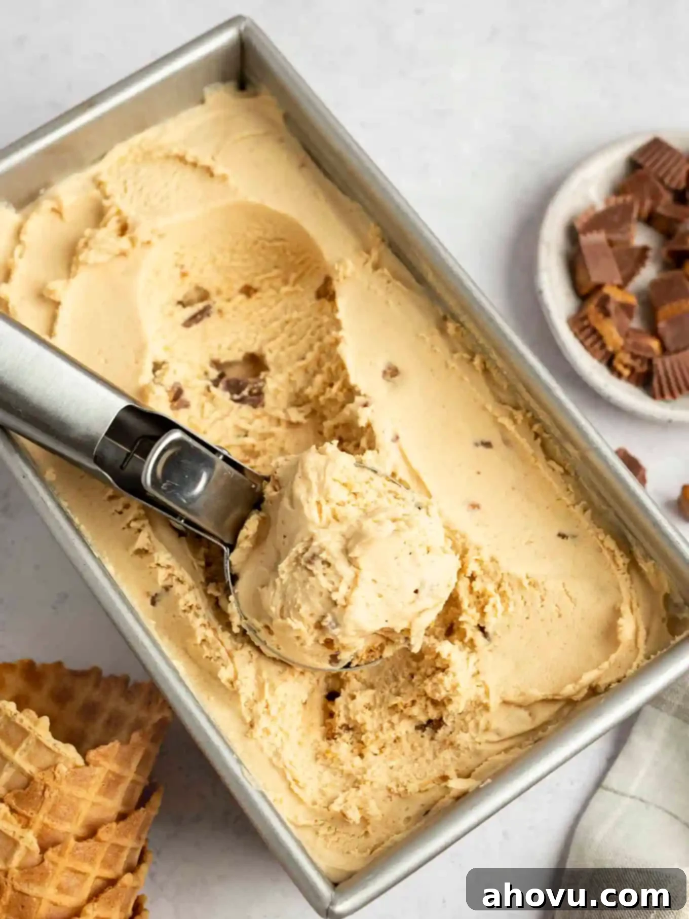Velvet Peanut Butter Freeze 10 A loaf pan filled with perfectly frozen peanut butter ice cream, with an ice cream scoop resting on top.