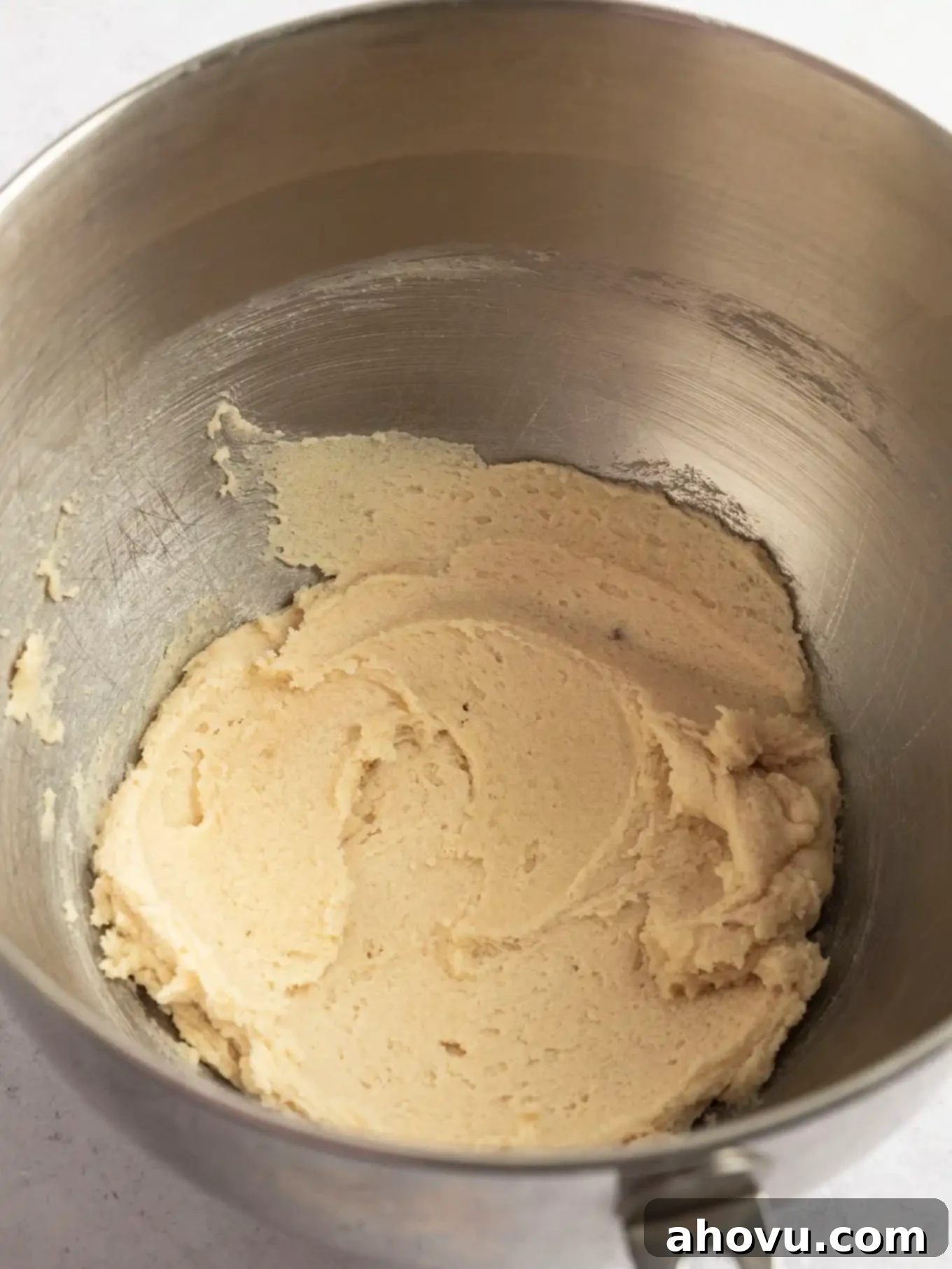 Close-up of perfectly creamed butter and light and dark sugars in the bowl of a stand mixer, illustrating the ideal texture before adding wet ingredients.