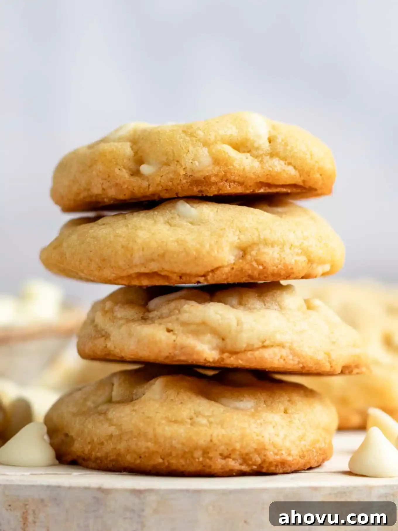 A beautifully arranged stack of four soft and chewy white chocolate chip cookies, showcasing their thick, rich texture and abundant white chocolate chunks.