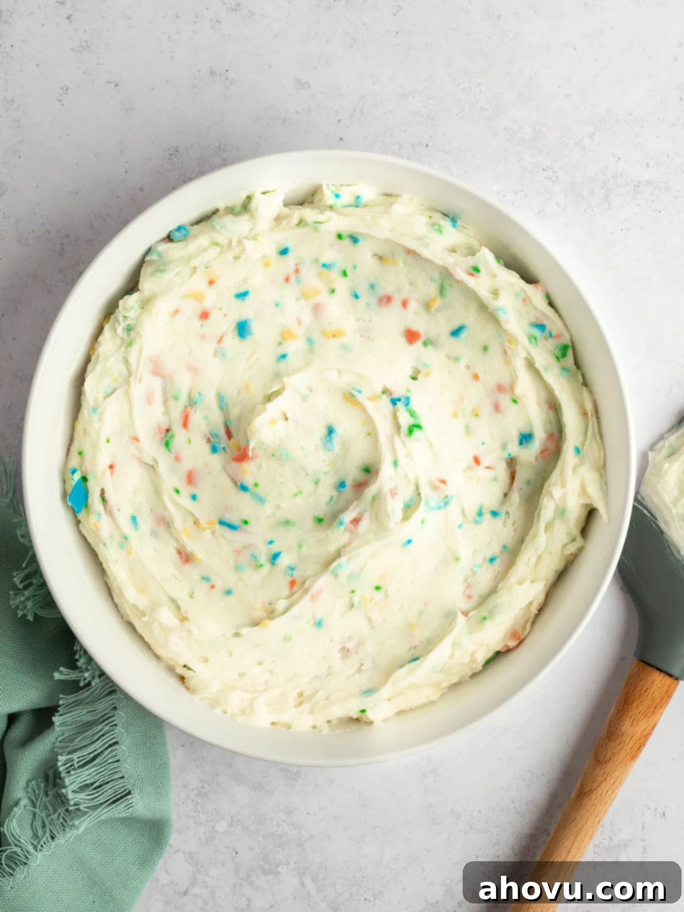 Joyful Confetti Frosting 2 An overhead view of a bowl of homemade rainbow chip frosting.