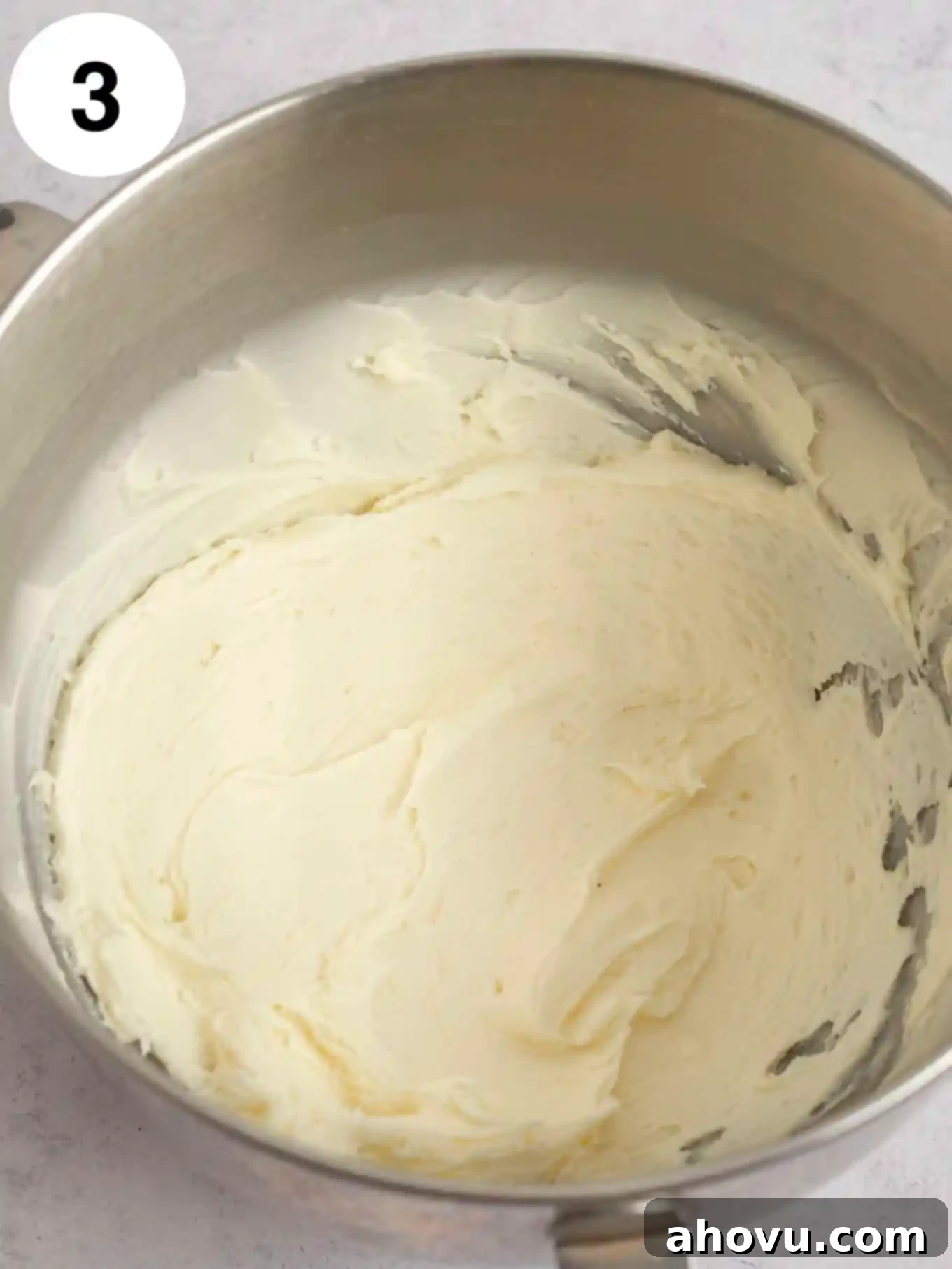 Joyful Confetti Frosting 6 An overhead view of beaten butter and cream cheese in a mixing bowl.