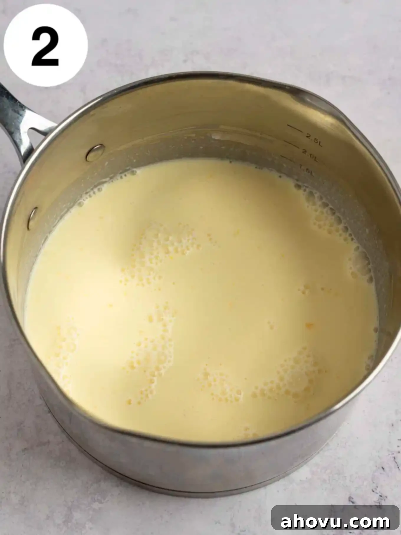 Creamy Vanilla Dream 5 An overhead view of uncooked vanilla pudding ingredients, including the egg, milk, and cream mixture, being whisked together with the dry ingredients in a saucepan before heating, illustrating the initial wet and dry ingredient combination.
