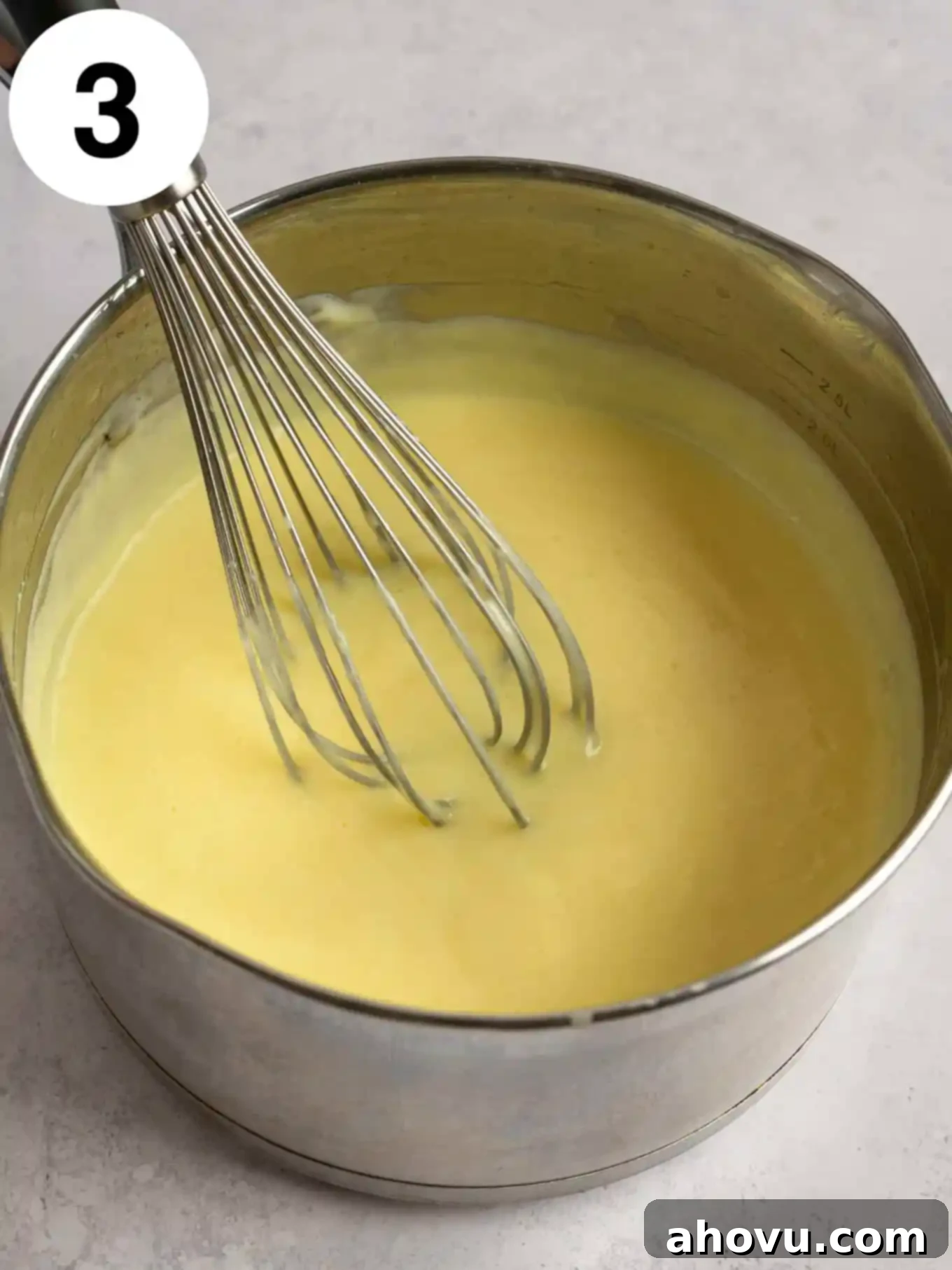 Creamy Vanilla Dream 6 An overhead view of the cooked vanilla pudding in a saucepan, showing its thickened, creamy consistency after being heated on the stovetop, indicating it's ready for the next step.