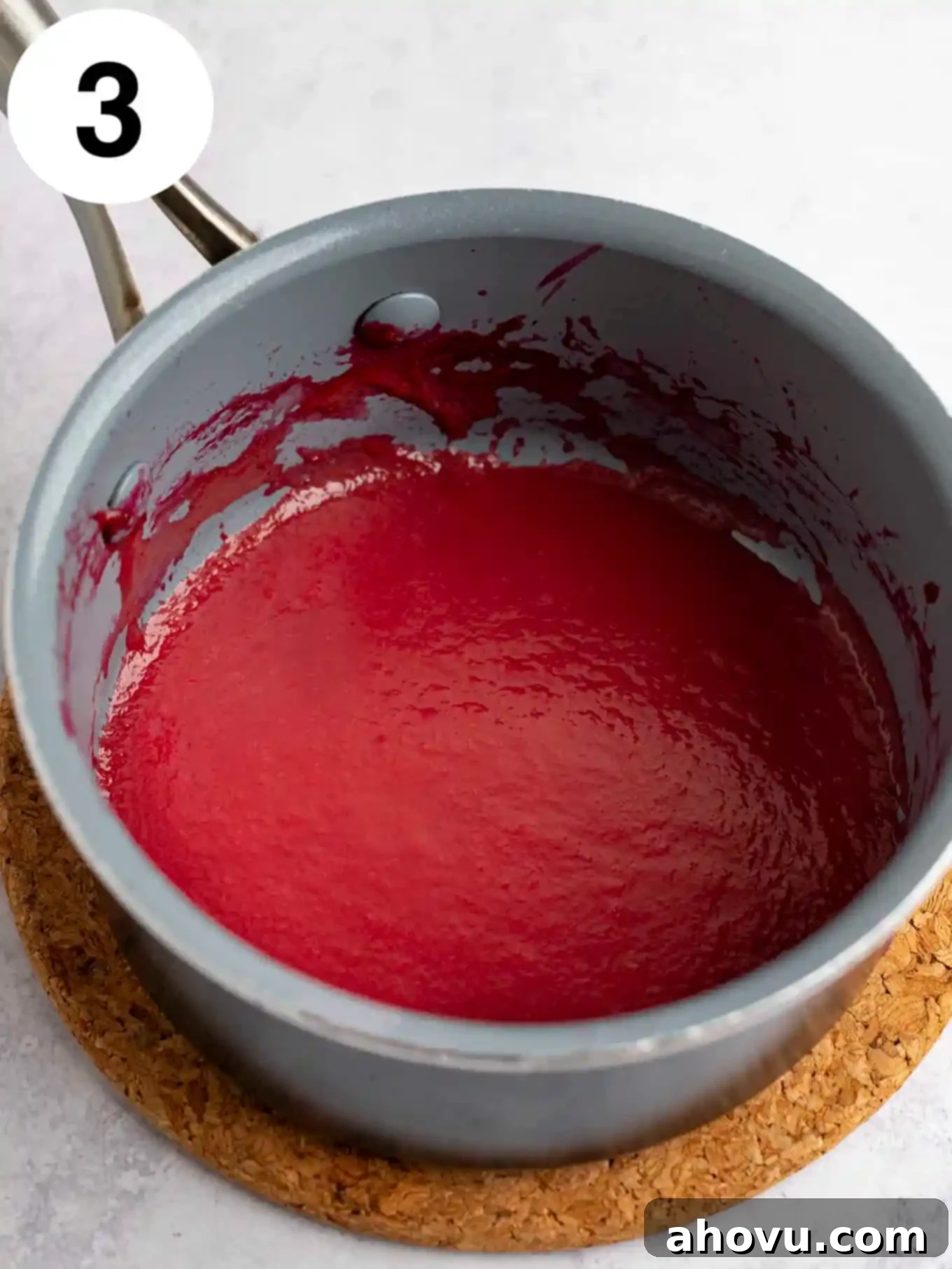 Reduced raspberry puree in a small saucepan. 