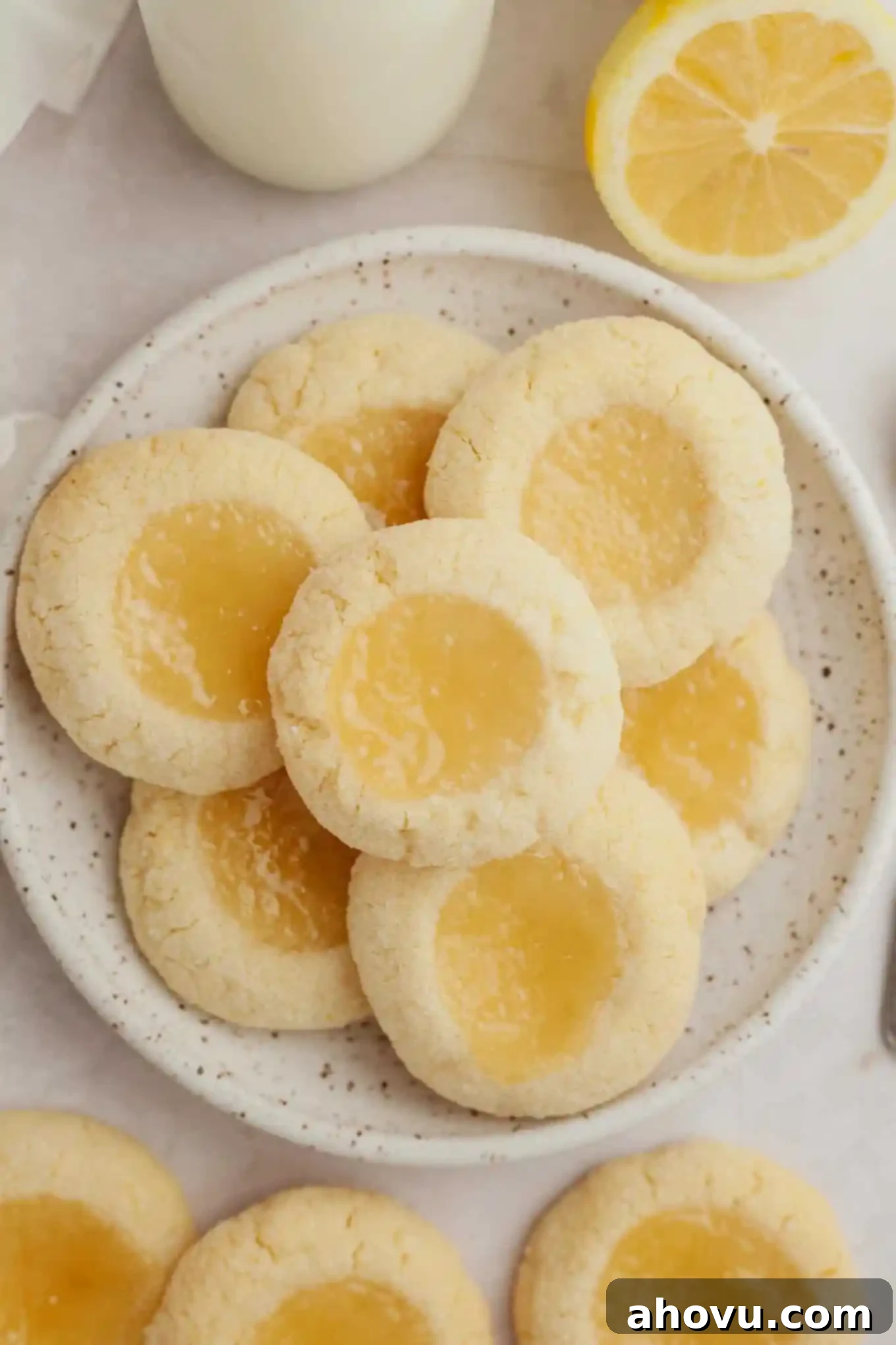 An overhead view of a beautiful white plate filled with perfectly baked lemon curd cookies, ready to be served.