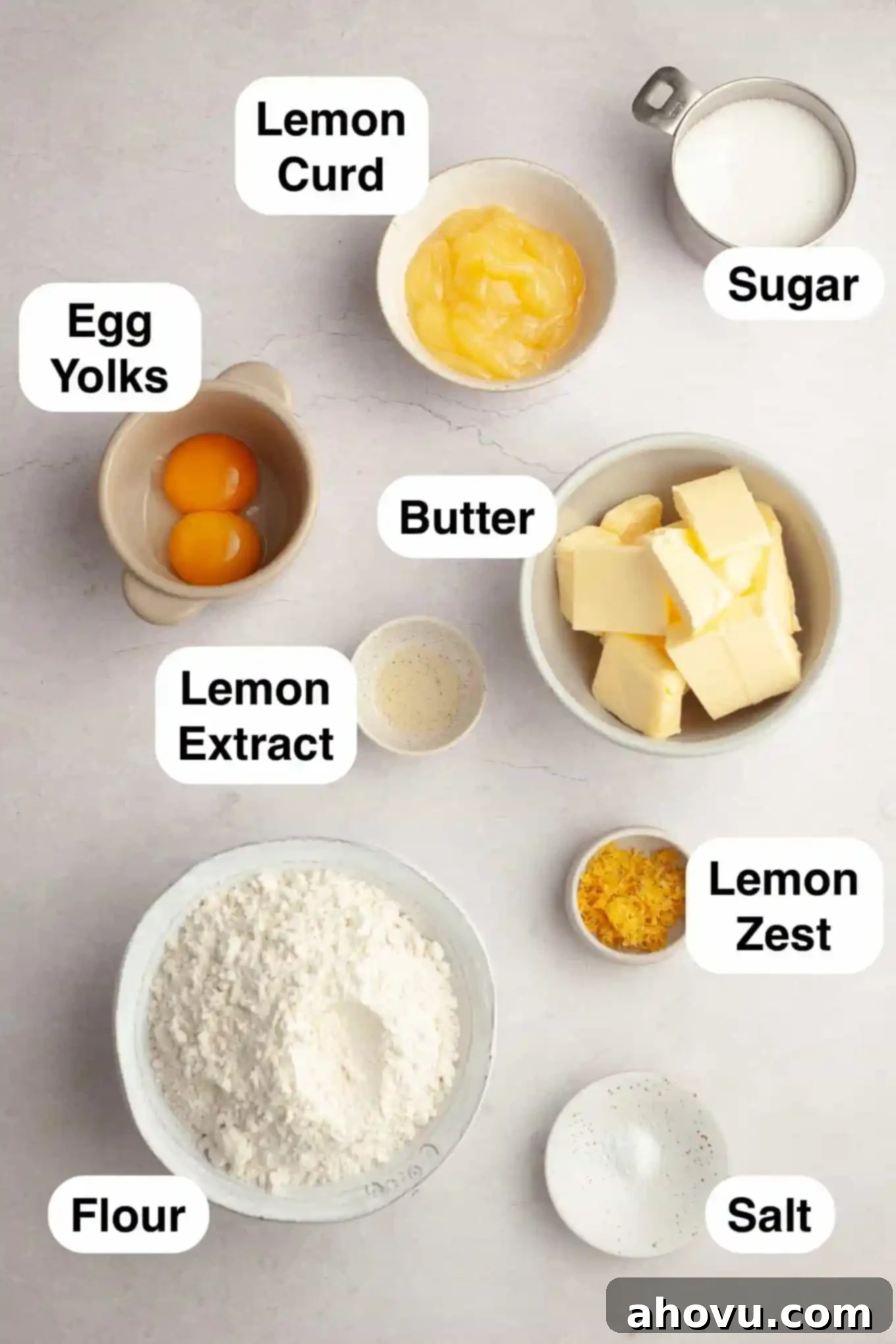 An overhead view of the key ingredients laid out on a clean surface, ready to be used for making lemon curd cookies.