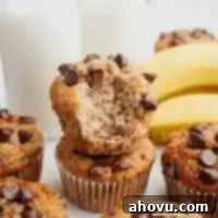 Banana chocolate chip muffins stacked on top of each other.