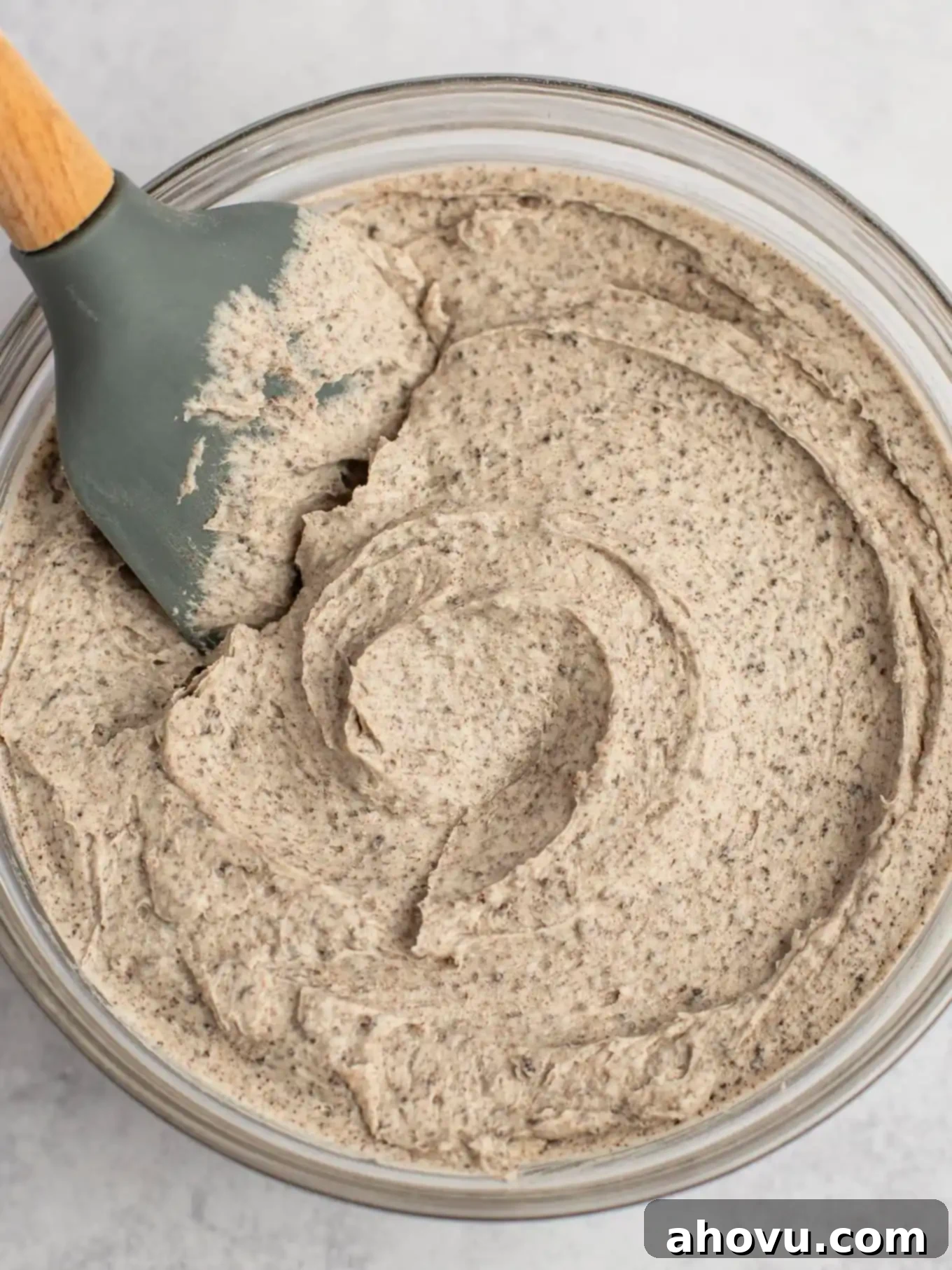 A glass mixing bowl filled with Oreo frosting.