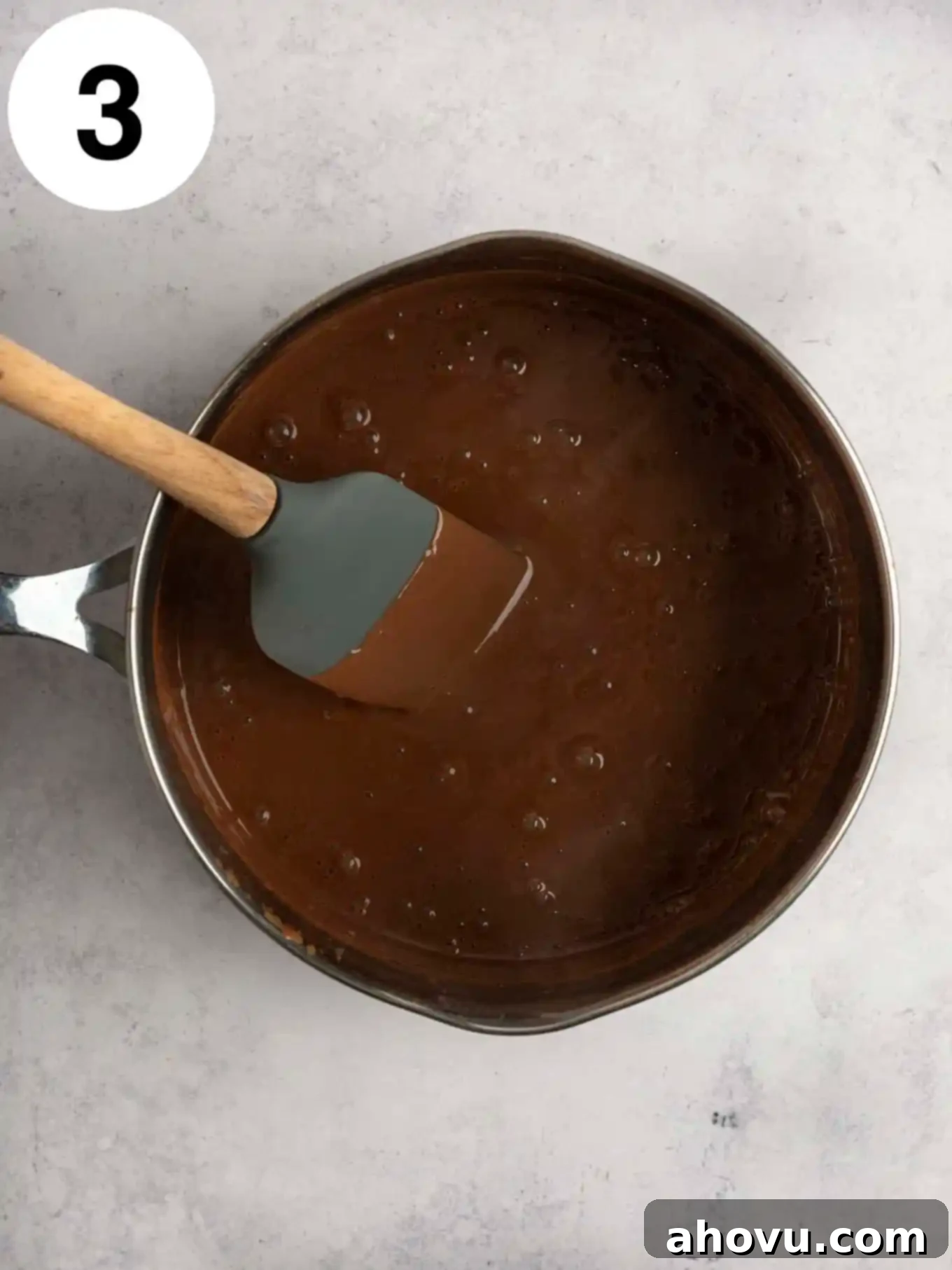 Decadent Chocolate Delight 6 An overhead view of the boiling mixture in a metal saucepan.