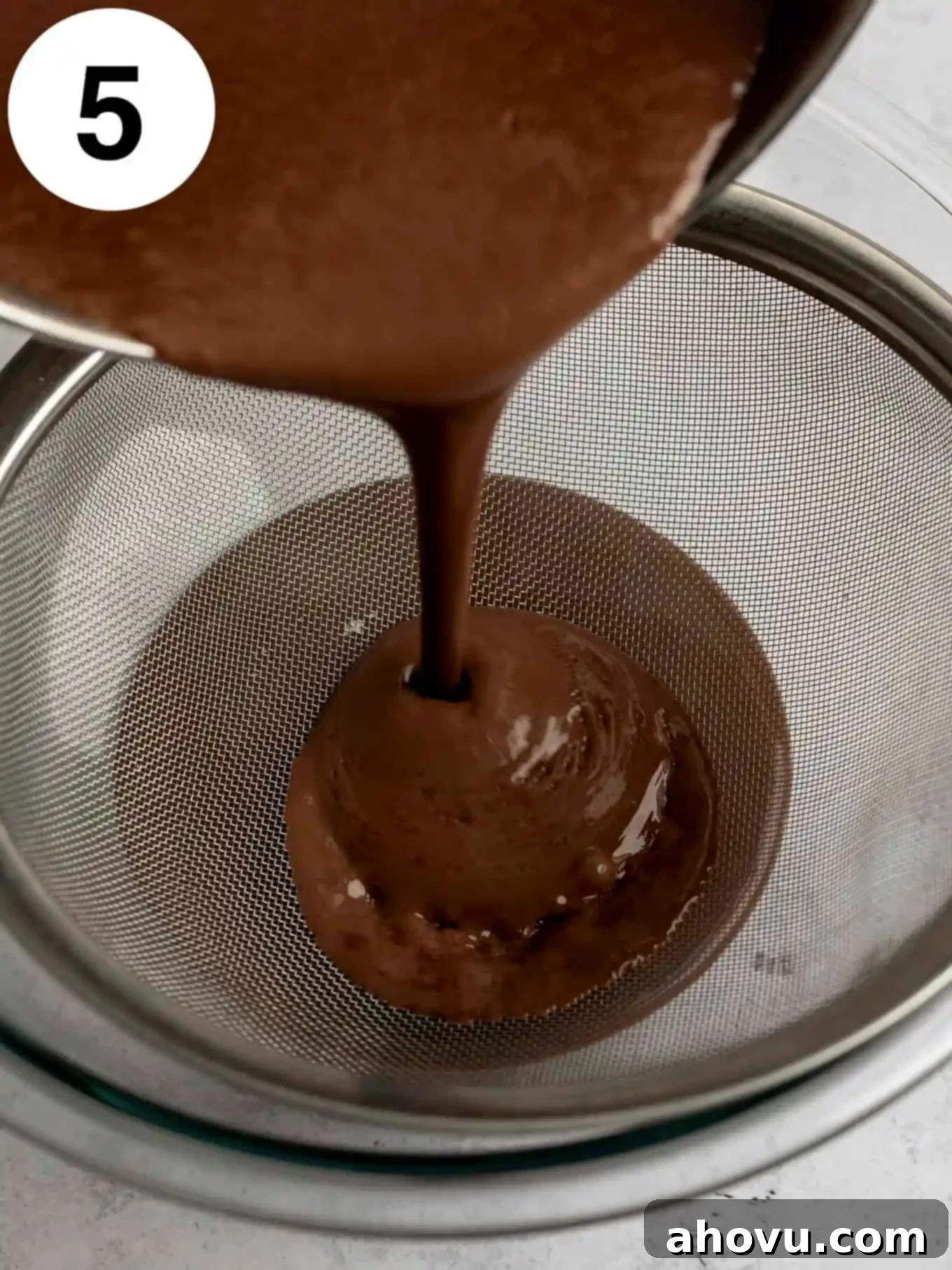 Decadent Chocolate Delight 8 A process shot showing chocolate pudding being strained through a fine mesh sieve.