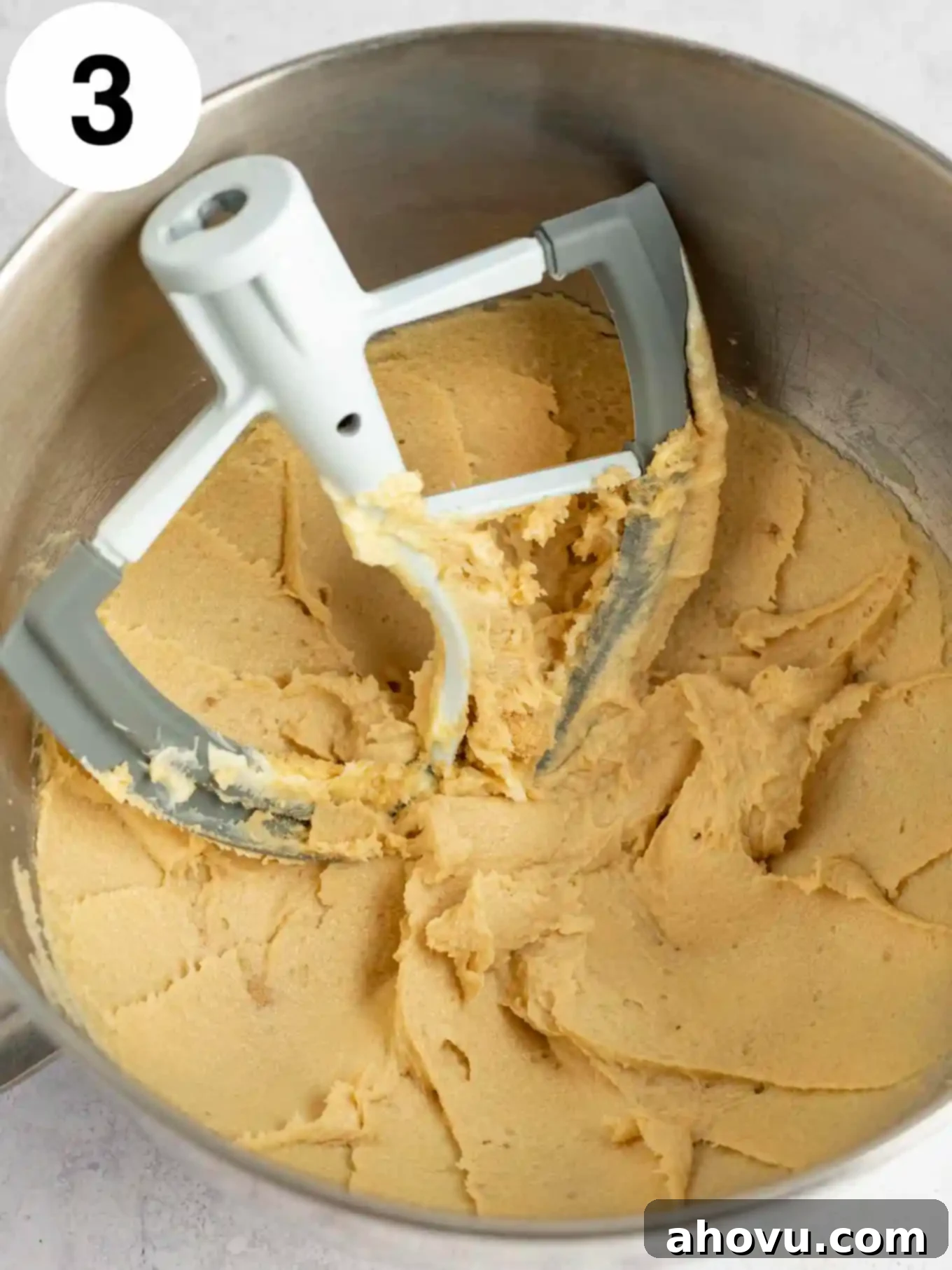 An overhead view of the stand mixer bowl after brown sugar has been beaten into the butter, showing a smooth, cohesive mixture with a rich color.