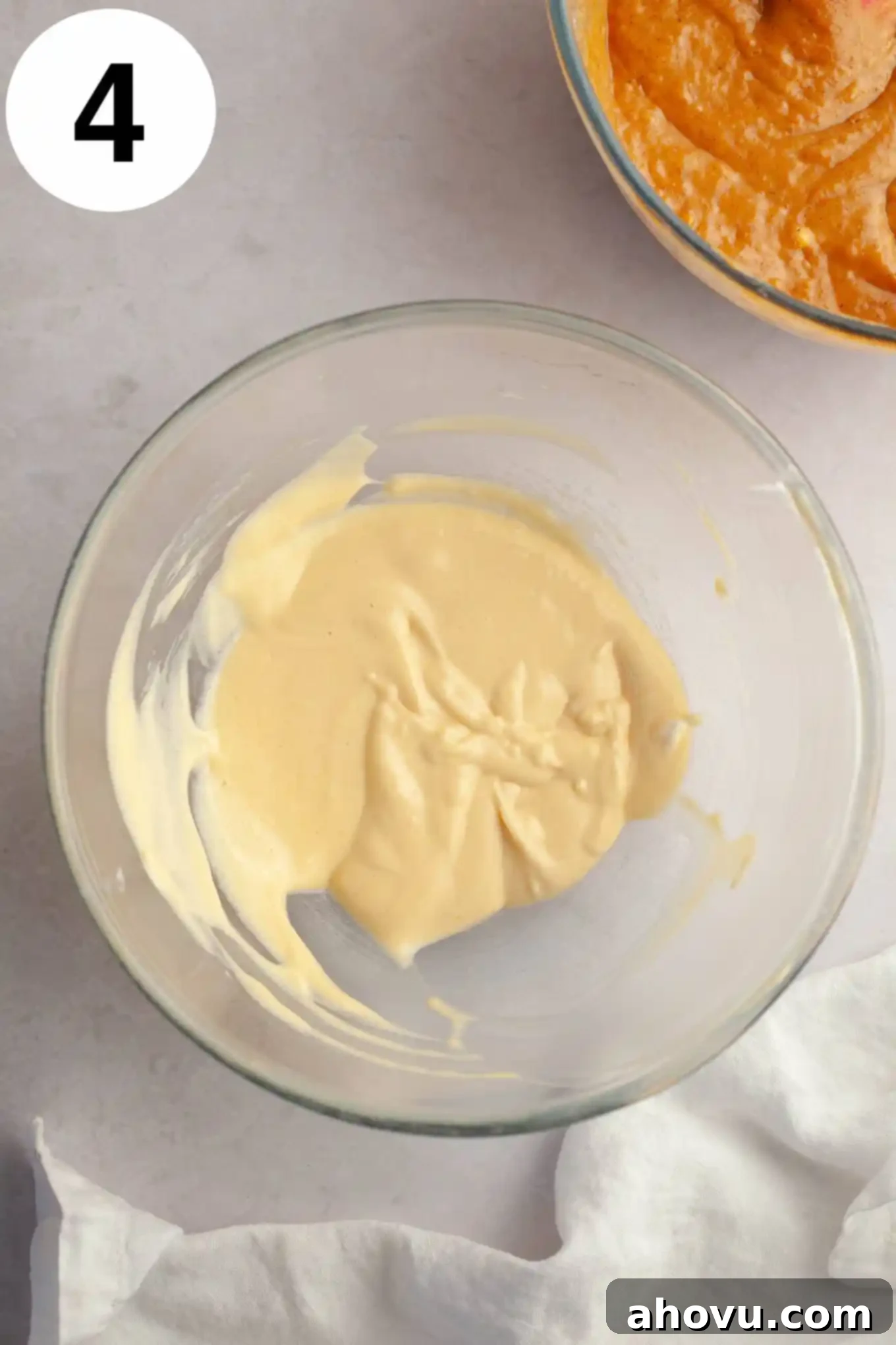 Pumpkin Swirl Cream Cheese Bread 7 An overhead view of a smooth, creamy cream cheese mixture in a glass bowl, ready for layering.