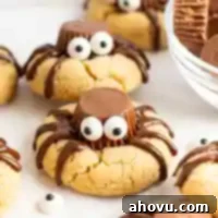 Creepy Crawly Cookie Bites 12 A closeup of spider cookies on a piece of parchment paper.