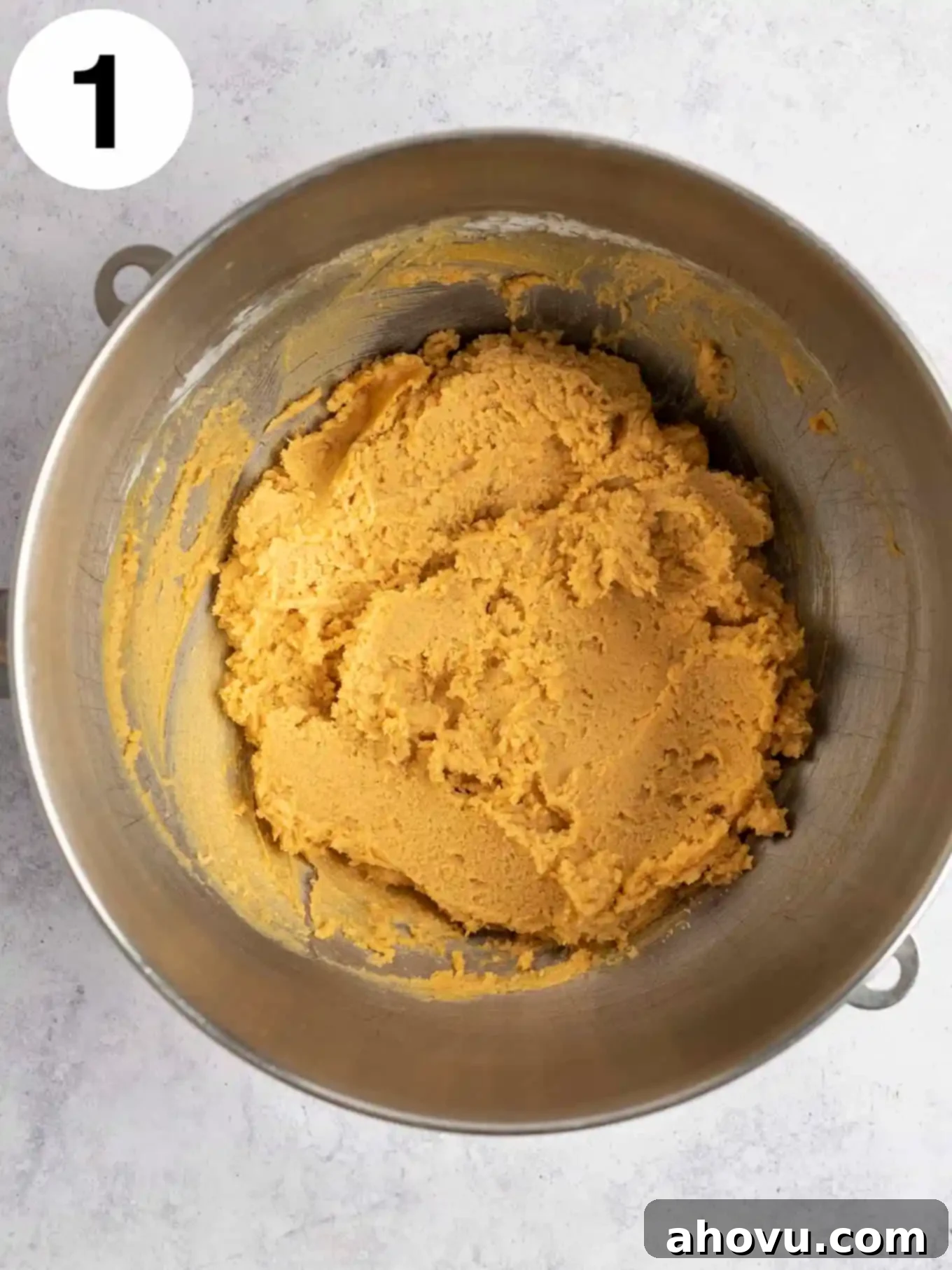 Creepy Crawly Cookie Bites 4 An overhead view of peanut butter cookie dough in a metal mixing bowl.