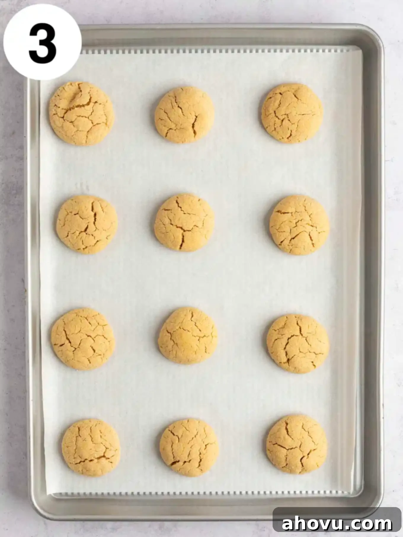 Creepy Crawly Cookie Bites 6 An overhead view of baked peanut butter cookies on a parchment paper-lined baking sheet.