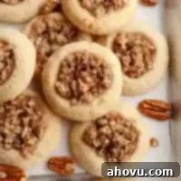 Several pecan pie cookies stacked on top of each other, showcasing their inviting appearance.