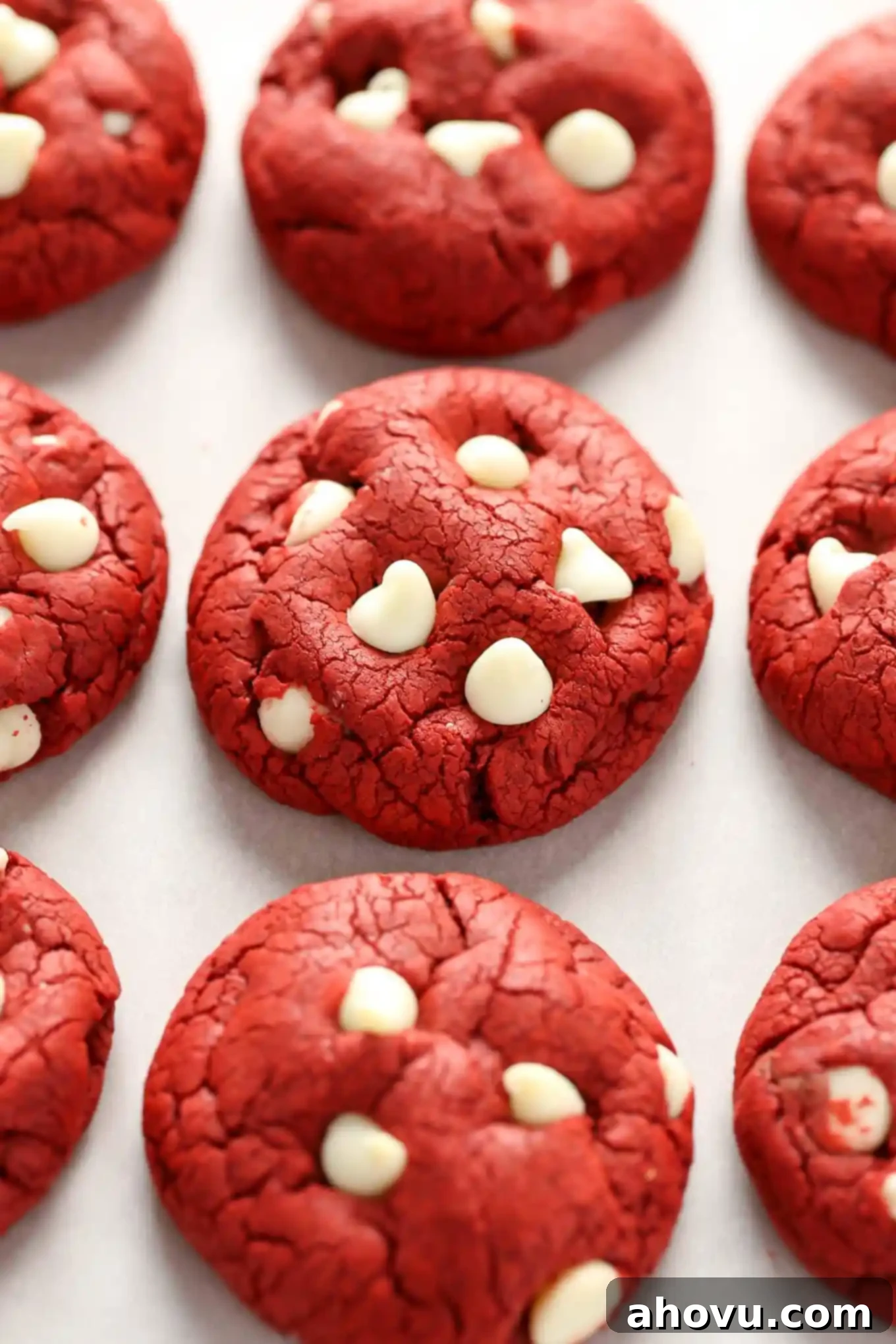 Effortless Red Velvet Delights 2 Three rows of white chocolate chip red velvet cookies, perfectly baked and ready to eat.