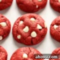 Effortless Red Velvet Delights 5 A plate of perfectly round Red Velvet Cake Mix Cookies with white chocolate chips.