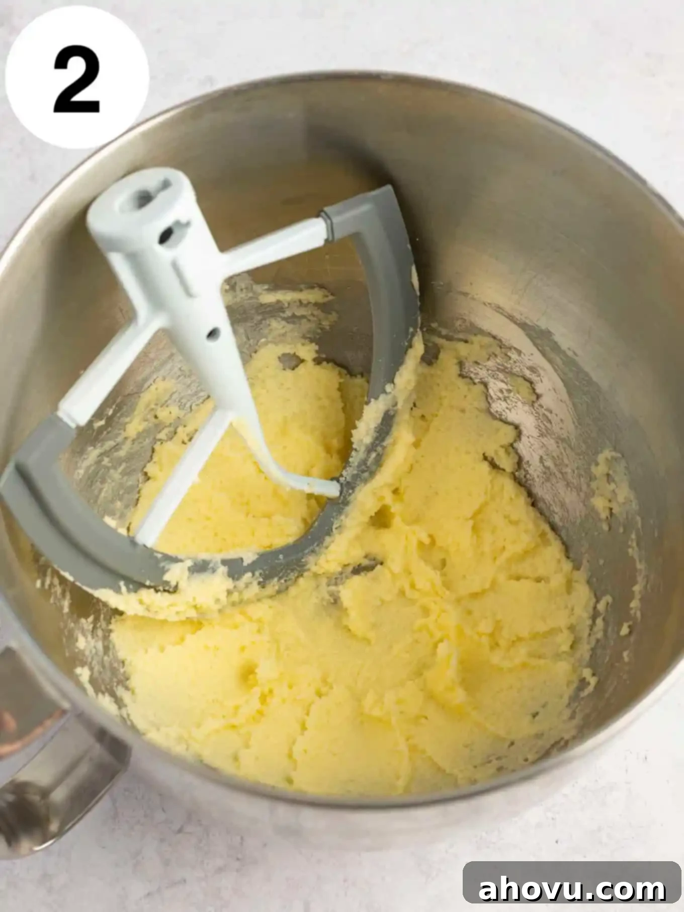 Guilt-Free Sugar Cookie Dough 5 An overhead shot of softened butter and granulated sugar being creamed together in a mixing bowl with a paddle attachment.