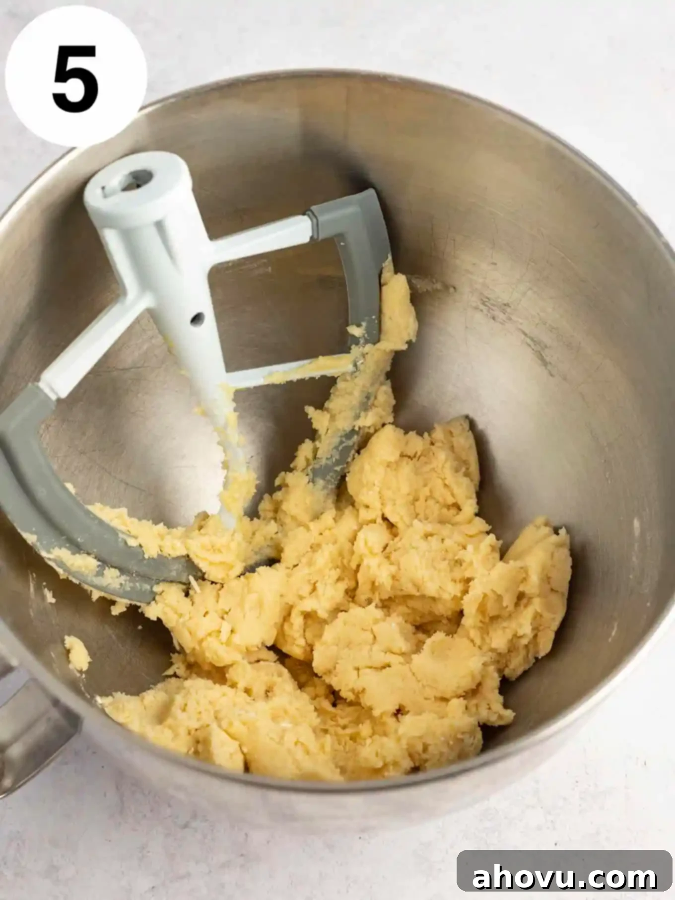 Guilt-Free Sugar Cookie Dough 8 An overhead shot of the sugar cookie dough forming a cohesive mass in a mixing bowl with the paddle attachment.