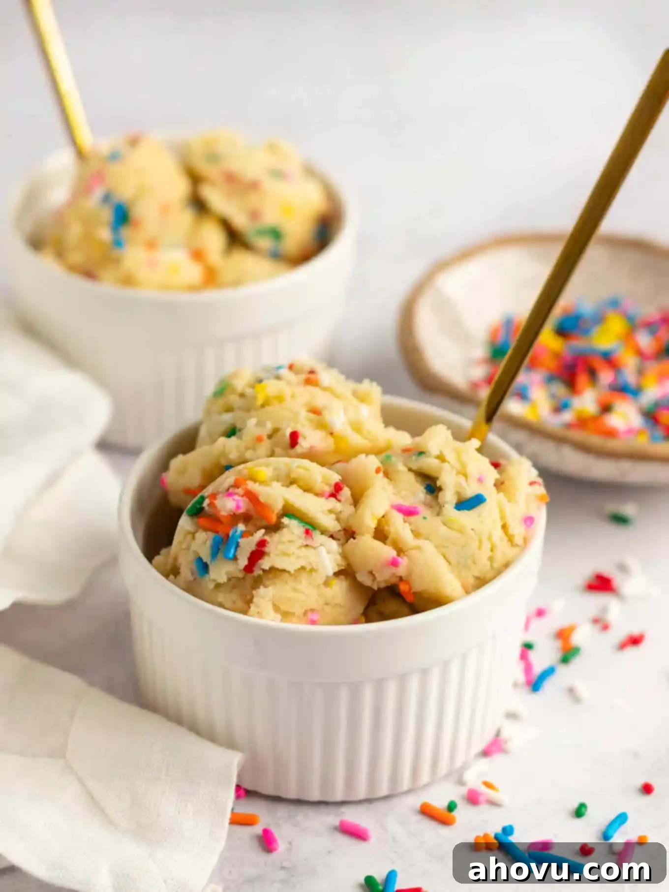 Guilt-Free Sugar Cookie Dough 10 Two small ramekins filled to the brim with colorful edible sugar cookie dough, garnished with extra sprinkles.