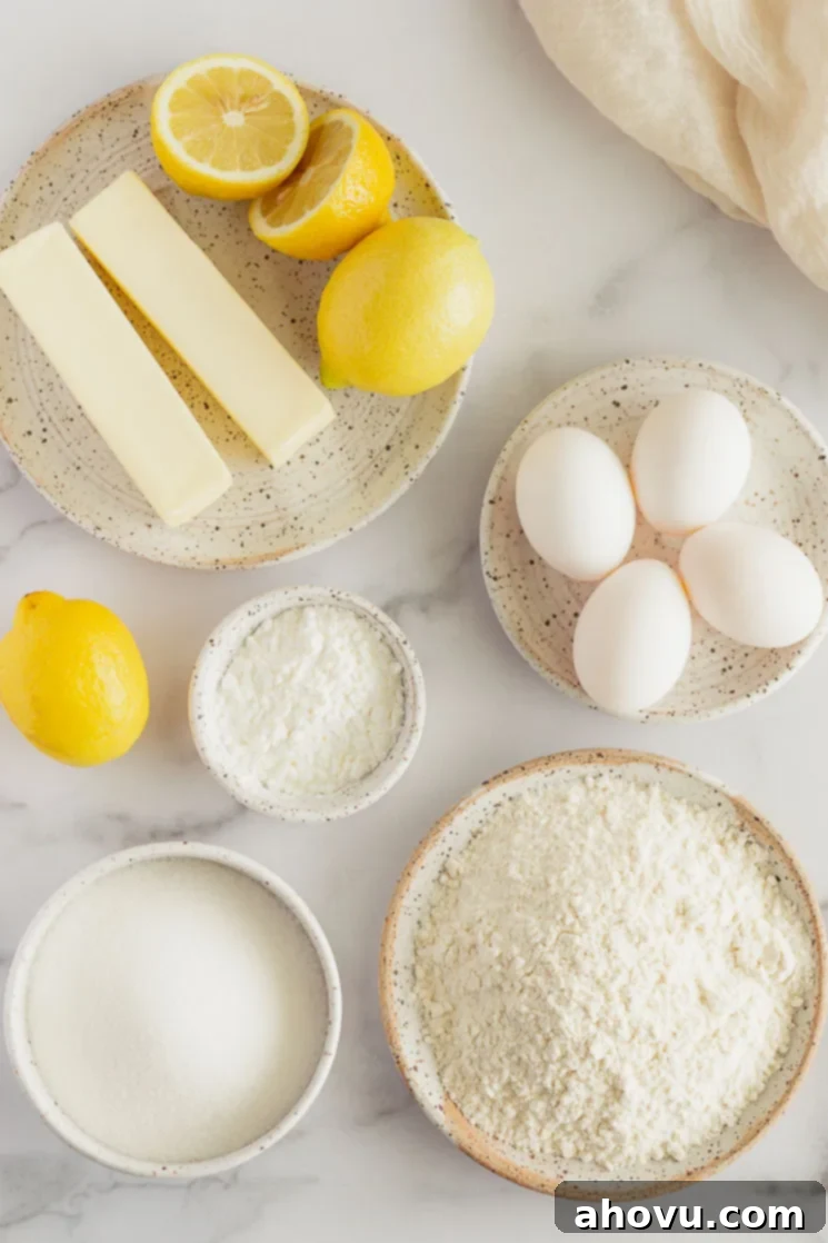 The ingredients for lemon bars in various bowls and plates on top of a marble surface.