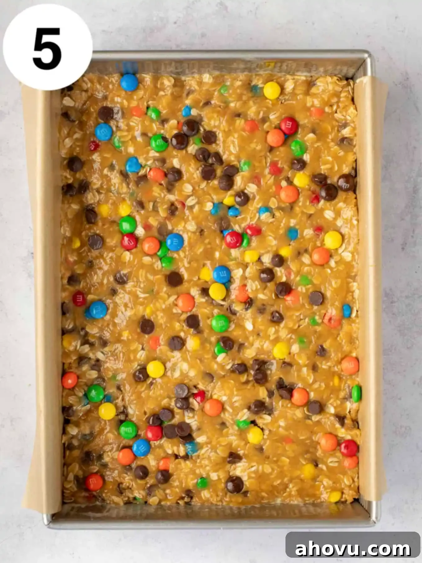 An overhead view of unbaked cookie dough in a baking dish. 