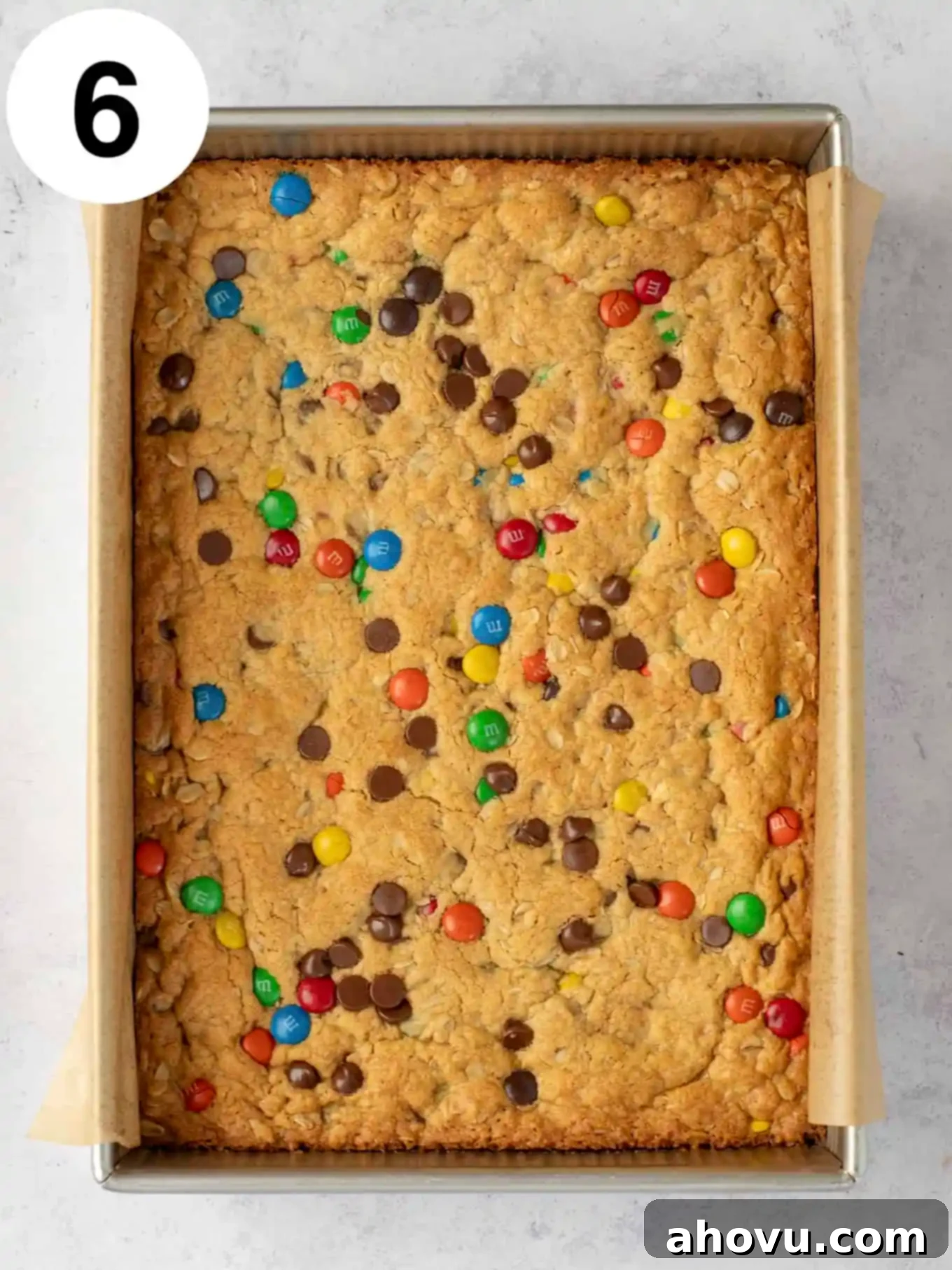 An overhead view of monster cookie bars in a baking dish. 