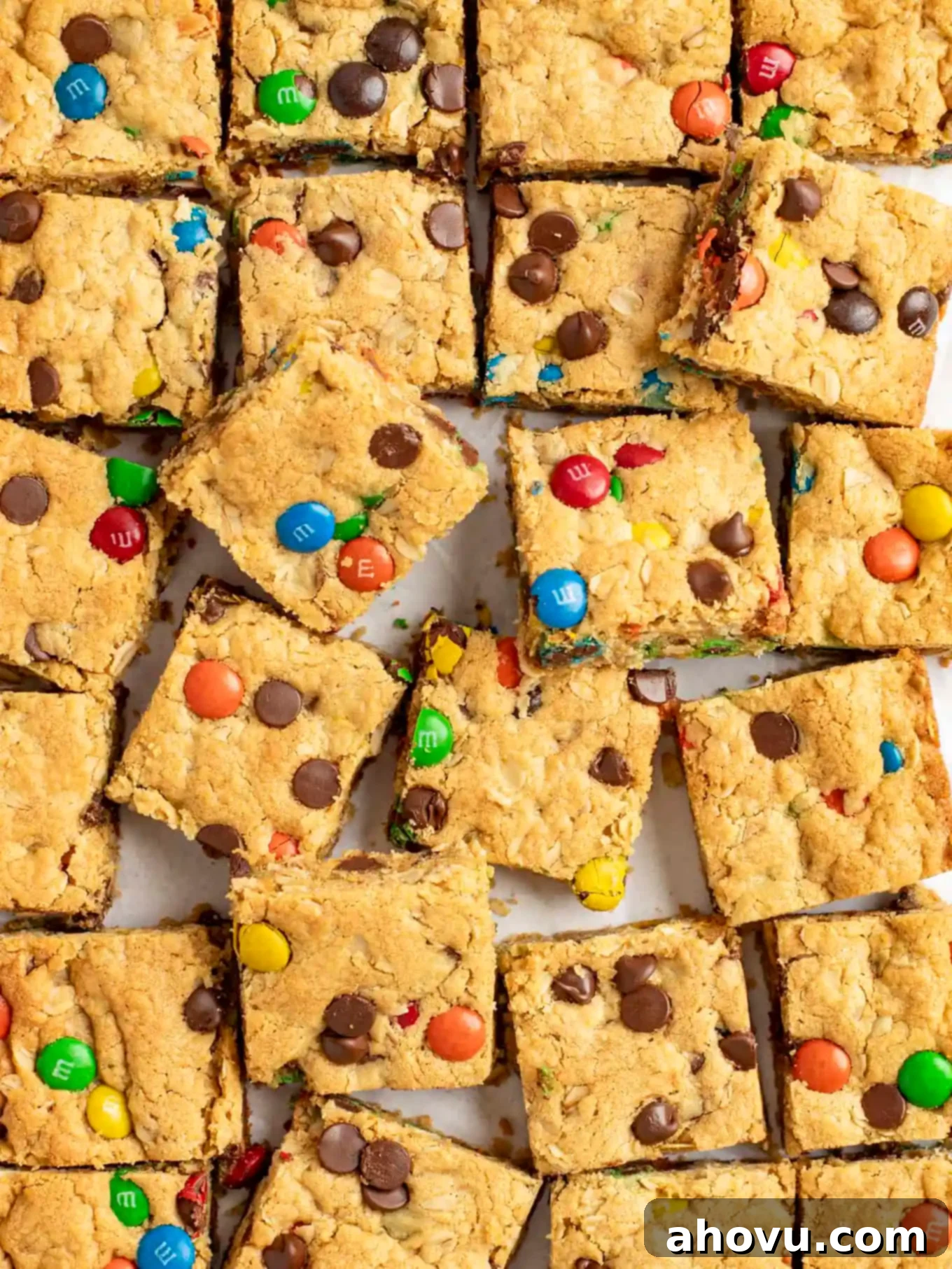 An overhead view of sliced bar cookies arranged on parchment paper. 
