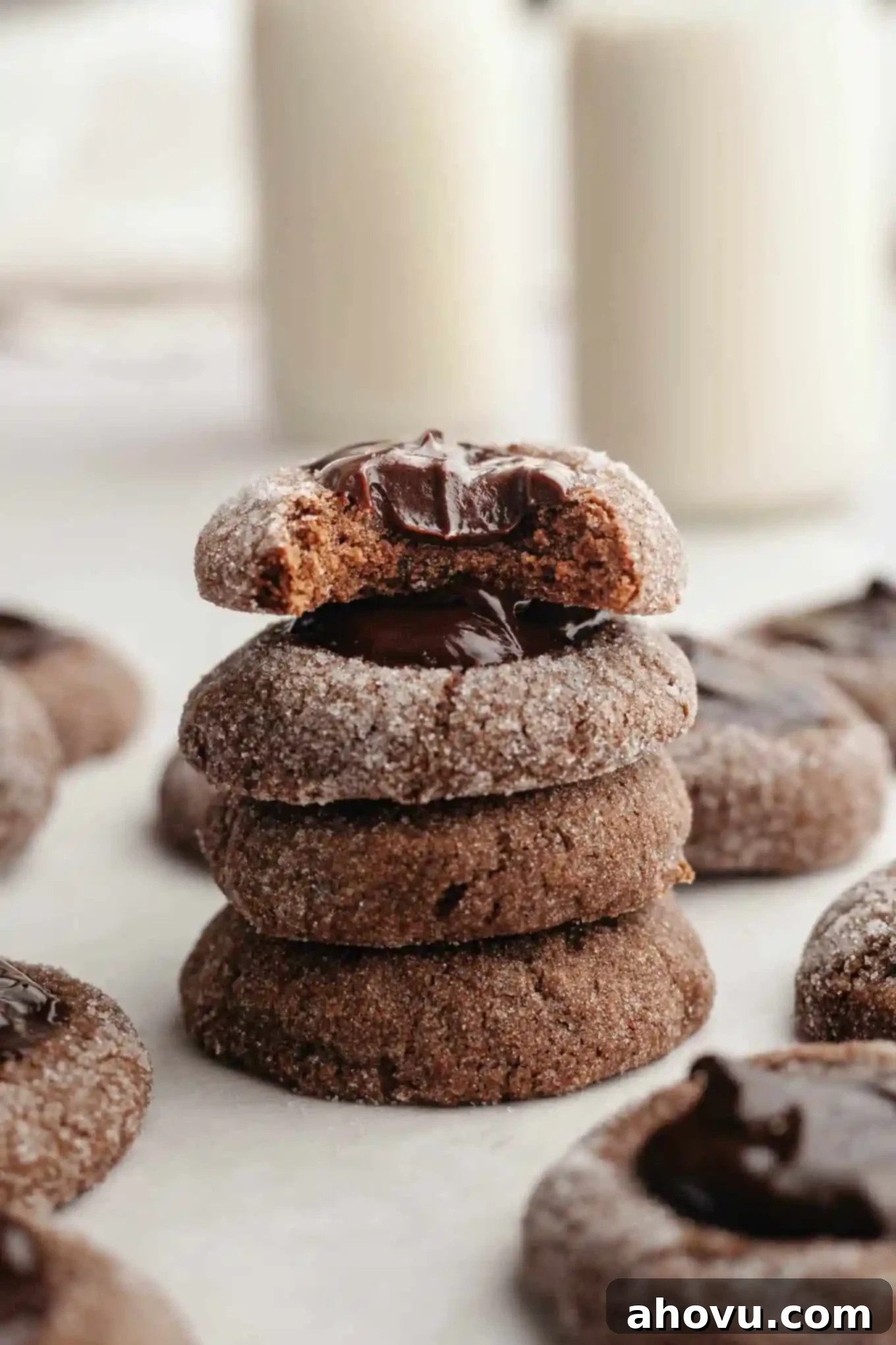 Irresistible Chocolate Thumbprint Cookies 2 Four chocolate thumbprints stacked on top of each other.
