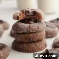 Irresistible Chocolate Thumbprint Cookies 12 A stack of four chocolate thumbprint cookies filled with chocolate ganache.