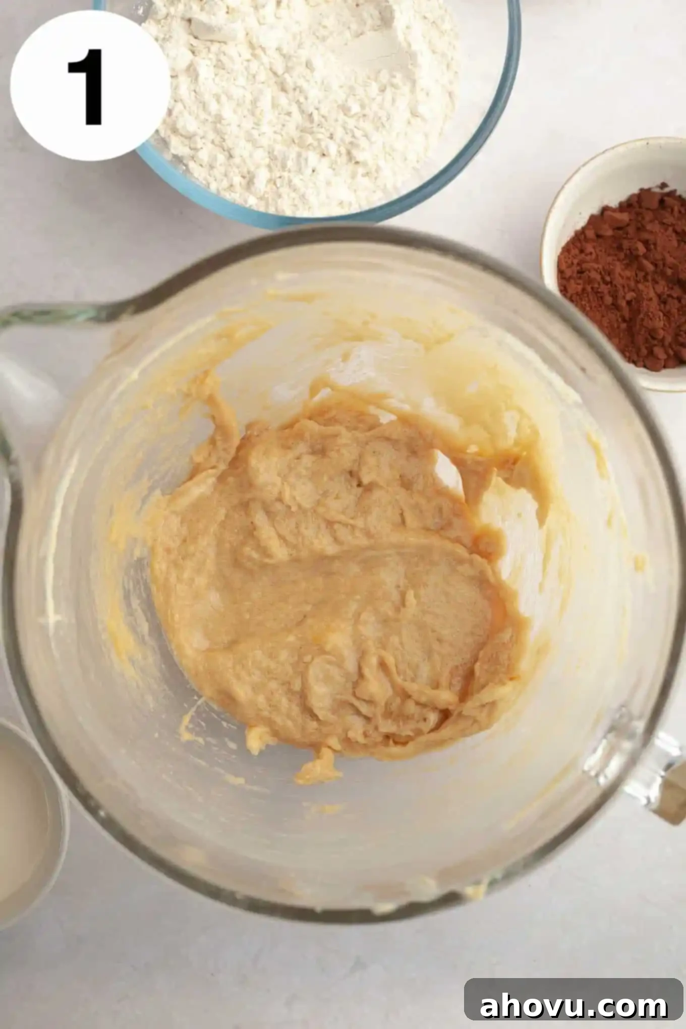 Irresistible Chocolate Thumbprint Cookies 4 An overhead view of creamed butter, brown sugar, egg, and vanilla in a glass mixing bowl.