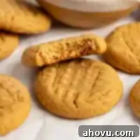 Several peanut butter cookies on a piece of parchment paper.